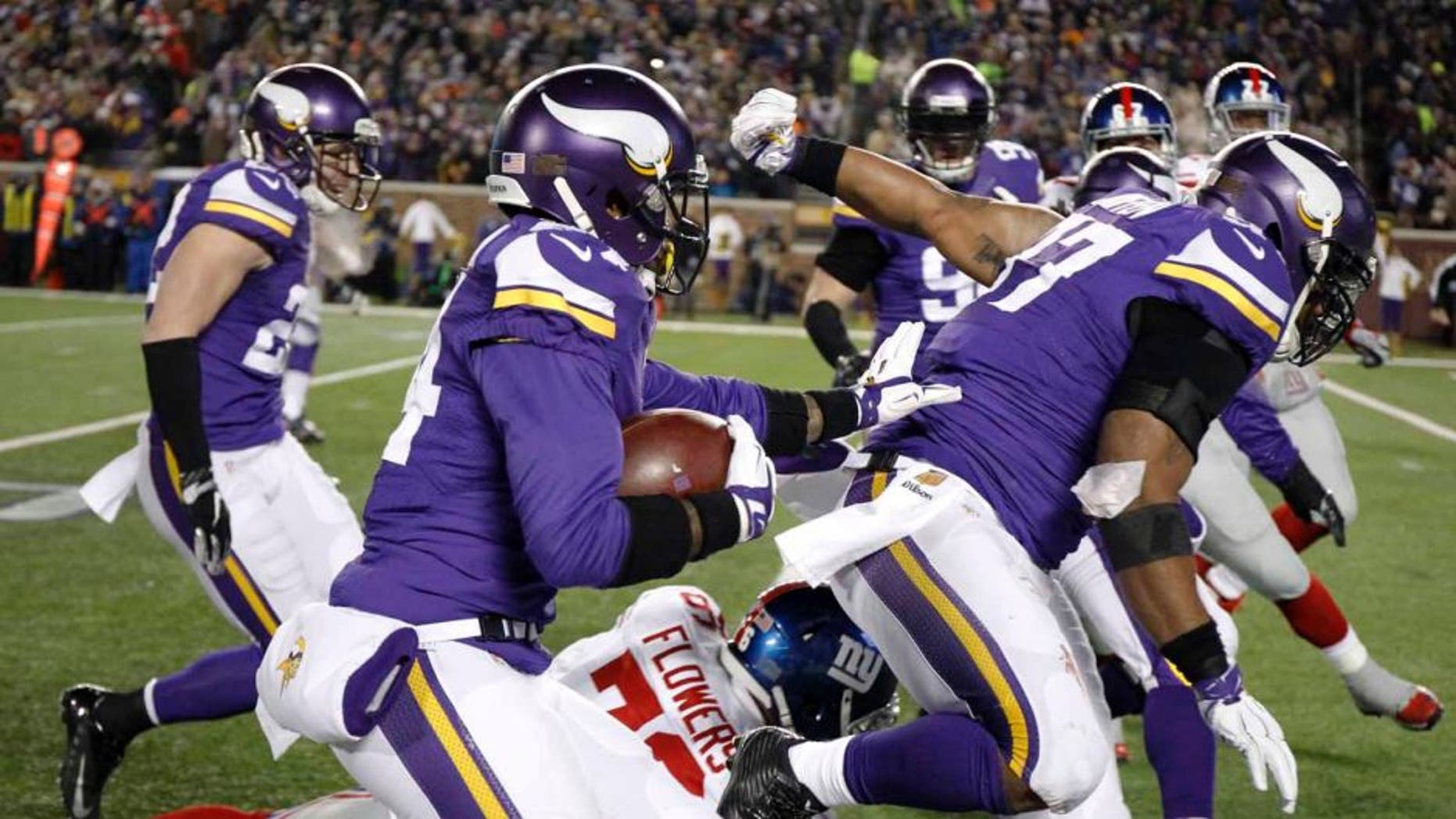 Minnesota Vikings cornerback Captain Munnerlyn runs with his interception of a pass from New York Giants quarterback Eli Manning during the second half Sunday, Dec. 27, 2015, in Minneapolis.