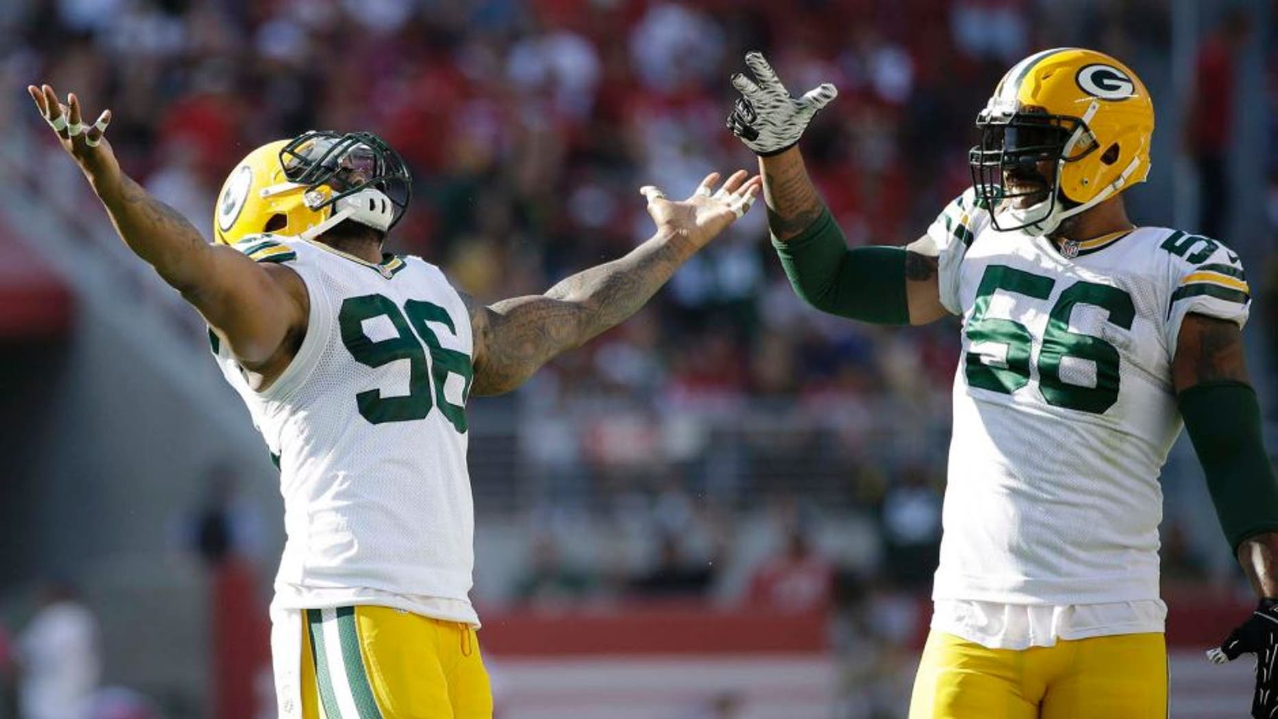 Green Bay Packers defensive tackle Mike Neal (left) and outside linebacker Julius Peppers celebrate during the second half against the San Francisco 49ers in Santa Clara, Calif., on Sunday, Oct. 4, 2015. The Packers won 17-3.