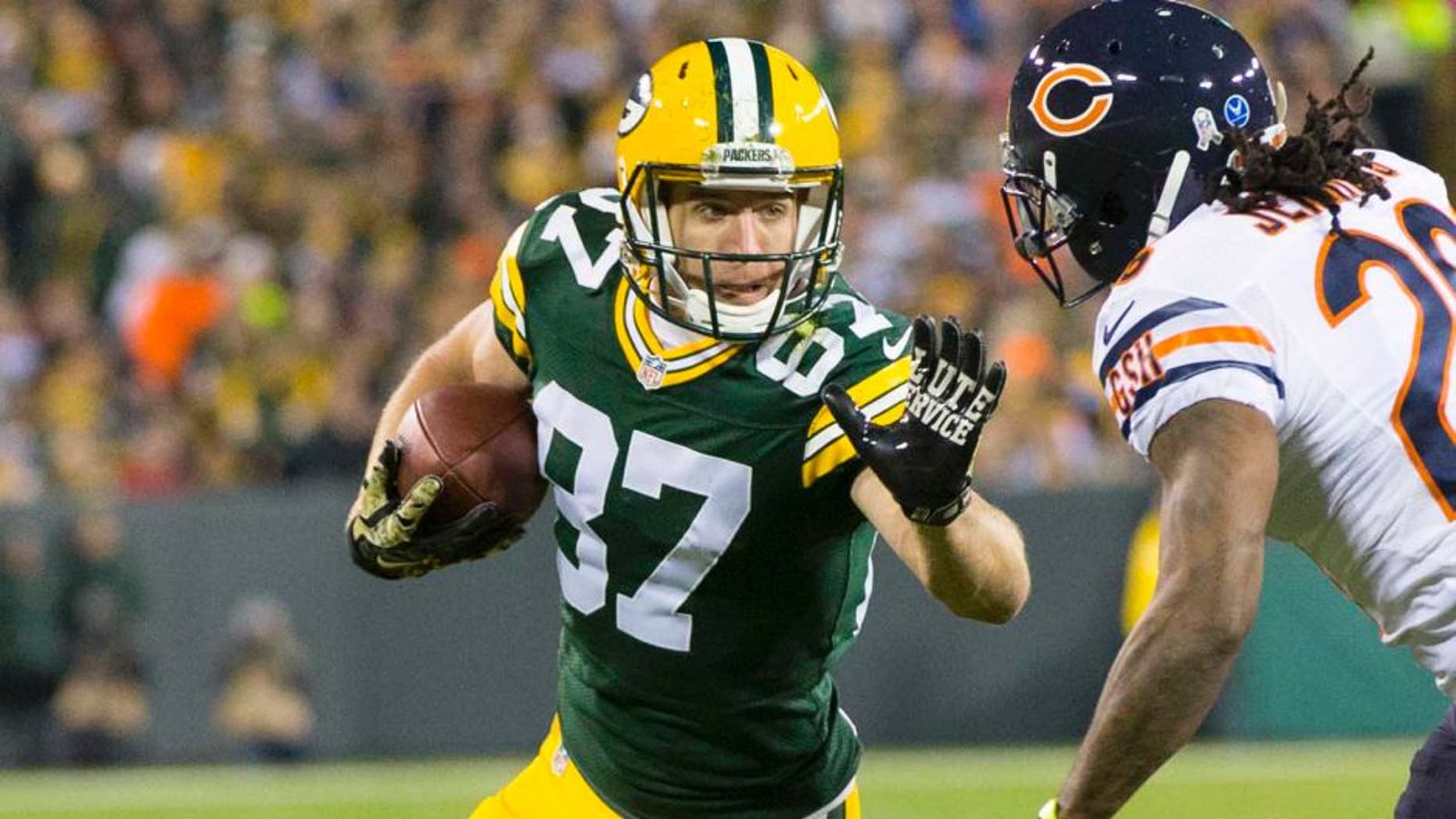 Nov 9, 2014; Green Bay, WI, USA; Green Bay Packers wide receiver Jordy Nelson (87) prepares to stiff arm Chicago Bears cornerback Tim Jennings (26) after catching a pass during the first quarter at Lambeau Field. Mandatory Credit: Jeff Hanisch-USA TODAY Sports