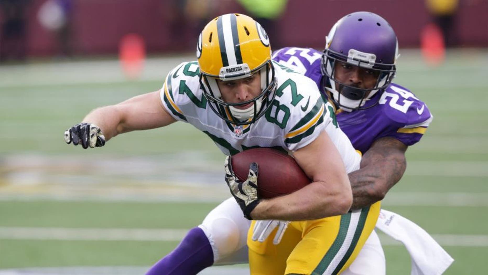 Green Bay Packers wide receiver Jordy Nelson (left) is tackled by Minnesota Vikings cornerback Captain Munnerlyn after making a reception during the second half.