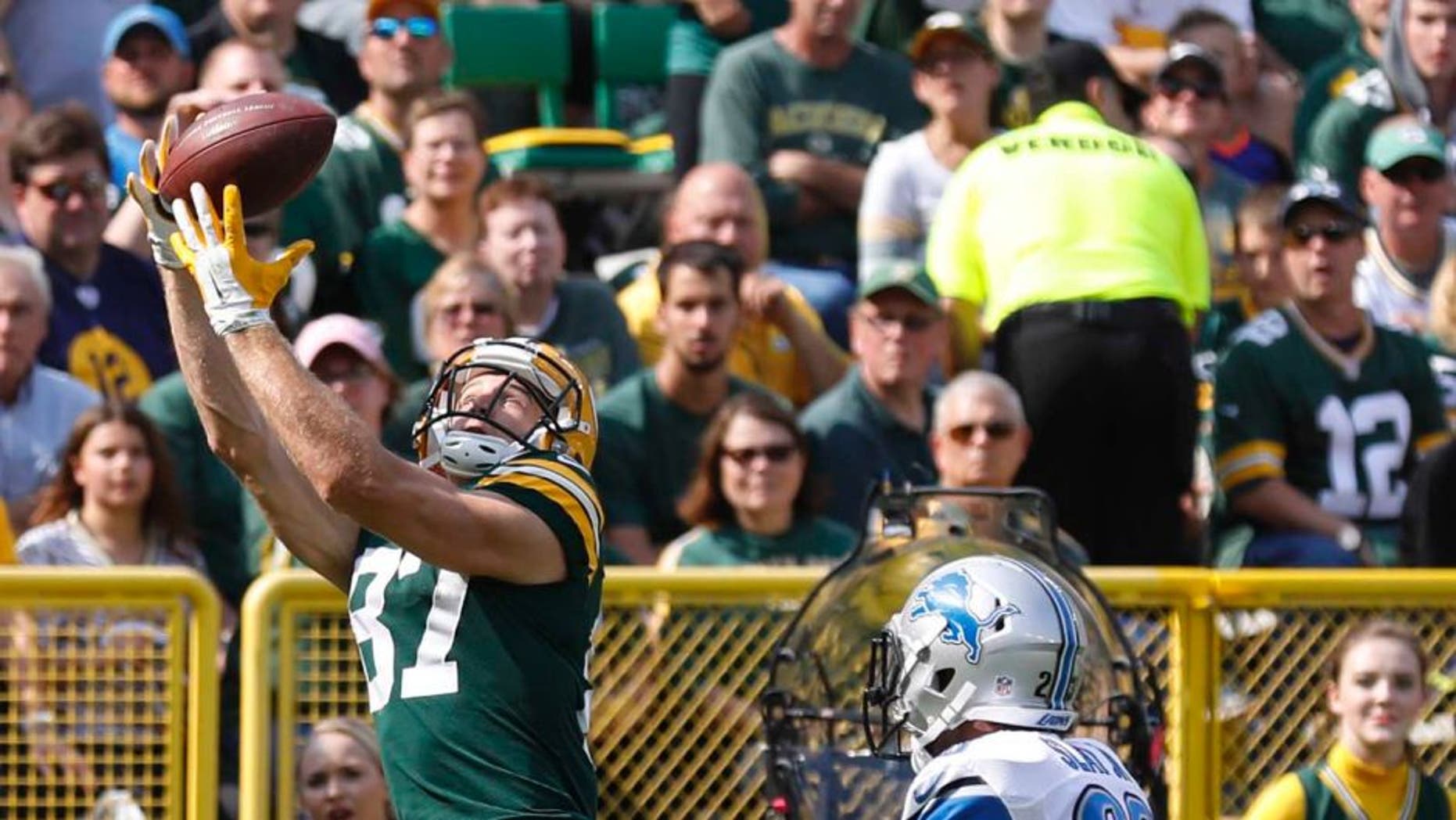 The Green Bay Packers' Jordy Nelson catches a touchdown pass in front of the Detroit Lions' Darius Slay during the first half Sunday, Sept. 25, 2016, in Green Bay, Wis.