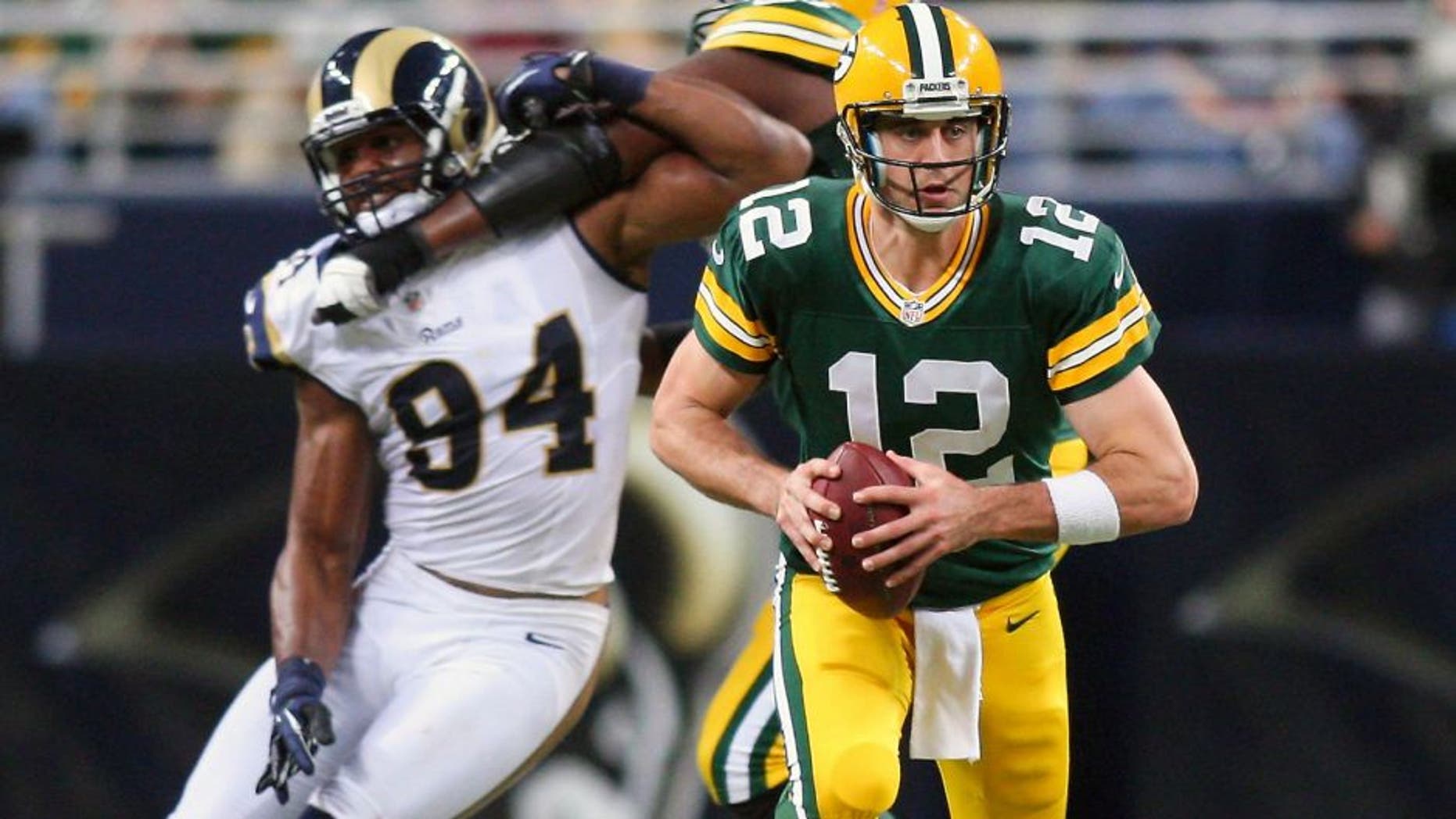 Oct 21, 2012; St. Louis, MO, USA; Green Bay Packers quarterback Aaron Rodgers (12) scrambles against the St. Louis Rams during the second half at Edward Jones Dome. The Packers defeated the Rams 30-20. Mandatory Credit: Scott Kane-USA TODAY Sports