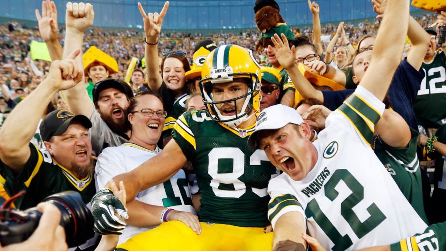 Green Bay Packers' Jeff Janis celebrates his touchdown catch with fans during the first half of an NFL preseason football game against the New Orleans Saints Thursday, Sept. 3, 2015, in Green Bay, Wis. (AP Photo/Mike Roemer)