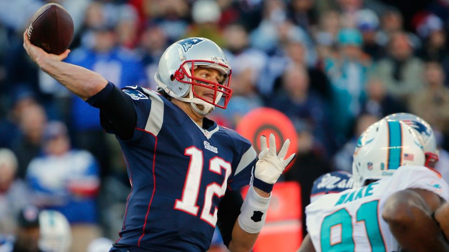 Dec 14, 2014; Foxborough, MA, USA; New England Patriots quarterback Tom Brady (12) throws the ball against the Miami Dolphins during the first half at Gillette Stadium. Mandatory Credit: Winslow Townson-USA TODAY Sports
