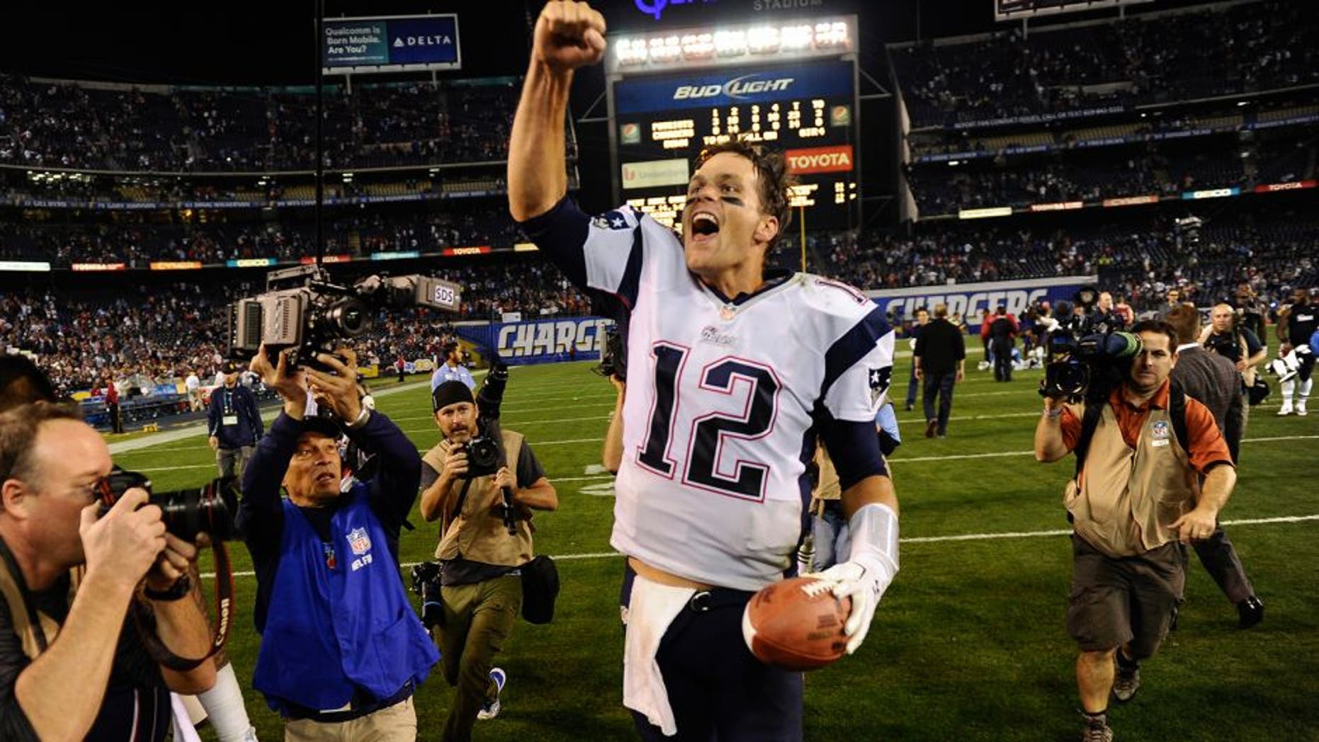 Dec 7, 2014; San Diego, CA, USA; New England Patriots quarterback Tom Brady (12) celebrates his teams 23-14 win over the San Diego Chargers at Qualcomm Stadium. Mandatory Credit: Robert Hanashiro-USA TODAY Sports