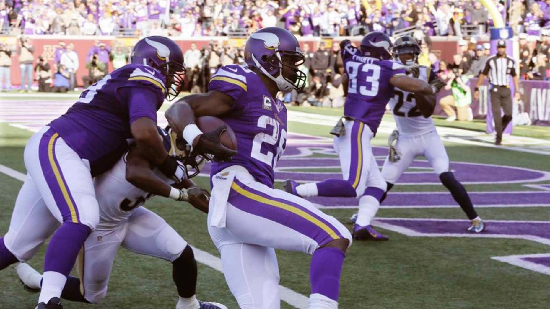 Minnesota Vikings running back Adrian Peterson gets into the end zone with a 6-yard run for a touchdown during the first half against the St. Louis Rams on Sunday, Nov. 8, 2015, in Minneapolis.