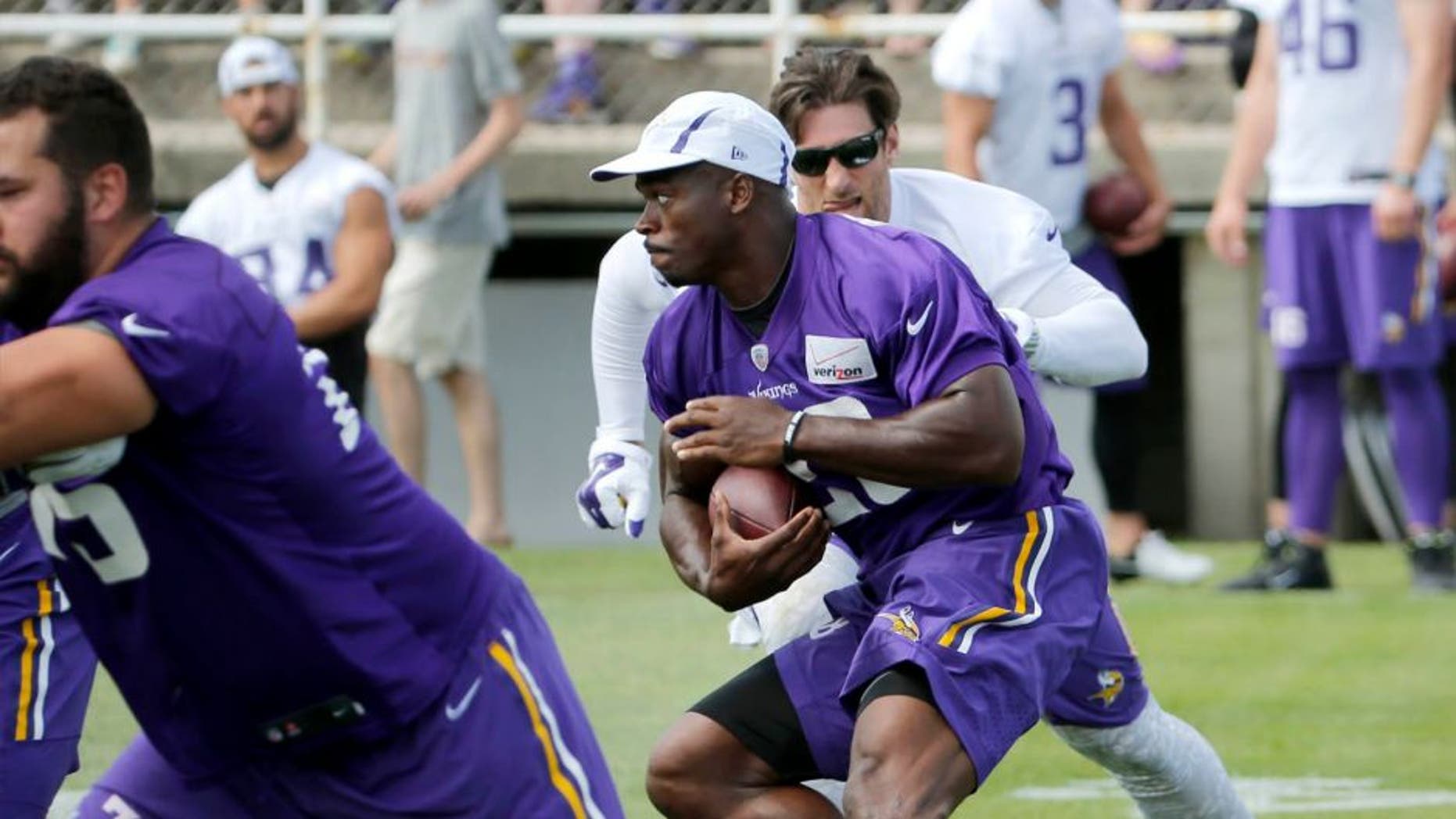 Sunday, July 26: Minnesota Vikings running back Adrian Peterson carries the ball during practice training camp on the campus of Minnesota State University in Mankato.