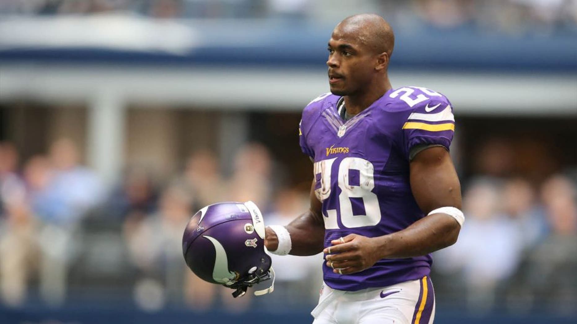 Nov 3, 2013; Arlington, TX, USA; Minnesota Vikings running back Adrian Peterson (28) with his helmet off returns to the huddle against the Dallas Cowboys at AT&T Stadium. Mandatory Credit: Matthew Emmons-USA TODAY Sports