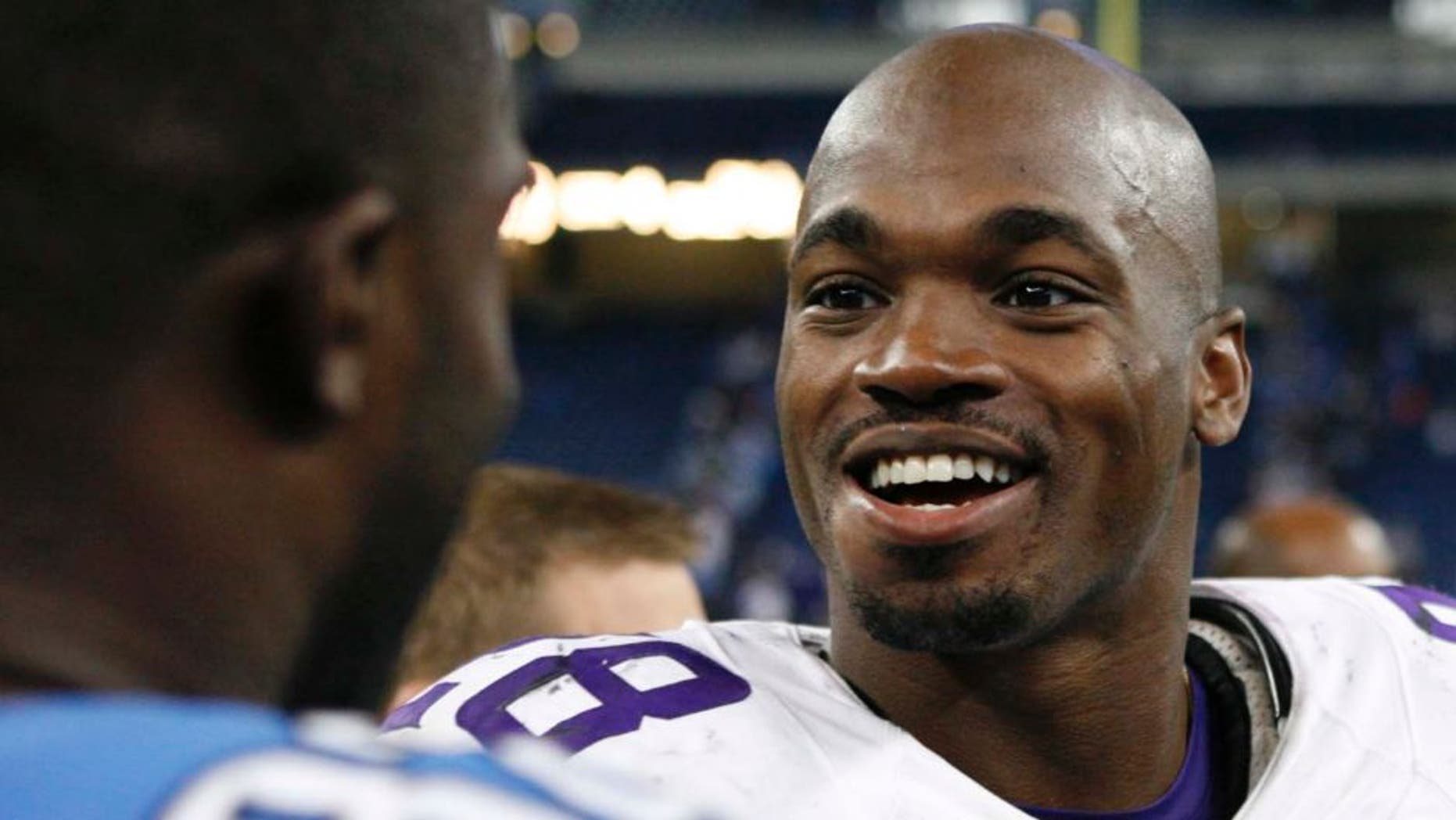 Minnesota Vikings running back Adrian Peterson talks with Detroit Lions strong safety James Ihedigbo after the game at Ford Field in Detroit on Sunday, Oct. 25, 2015.