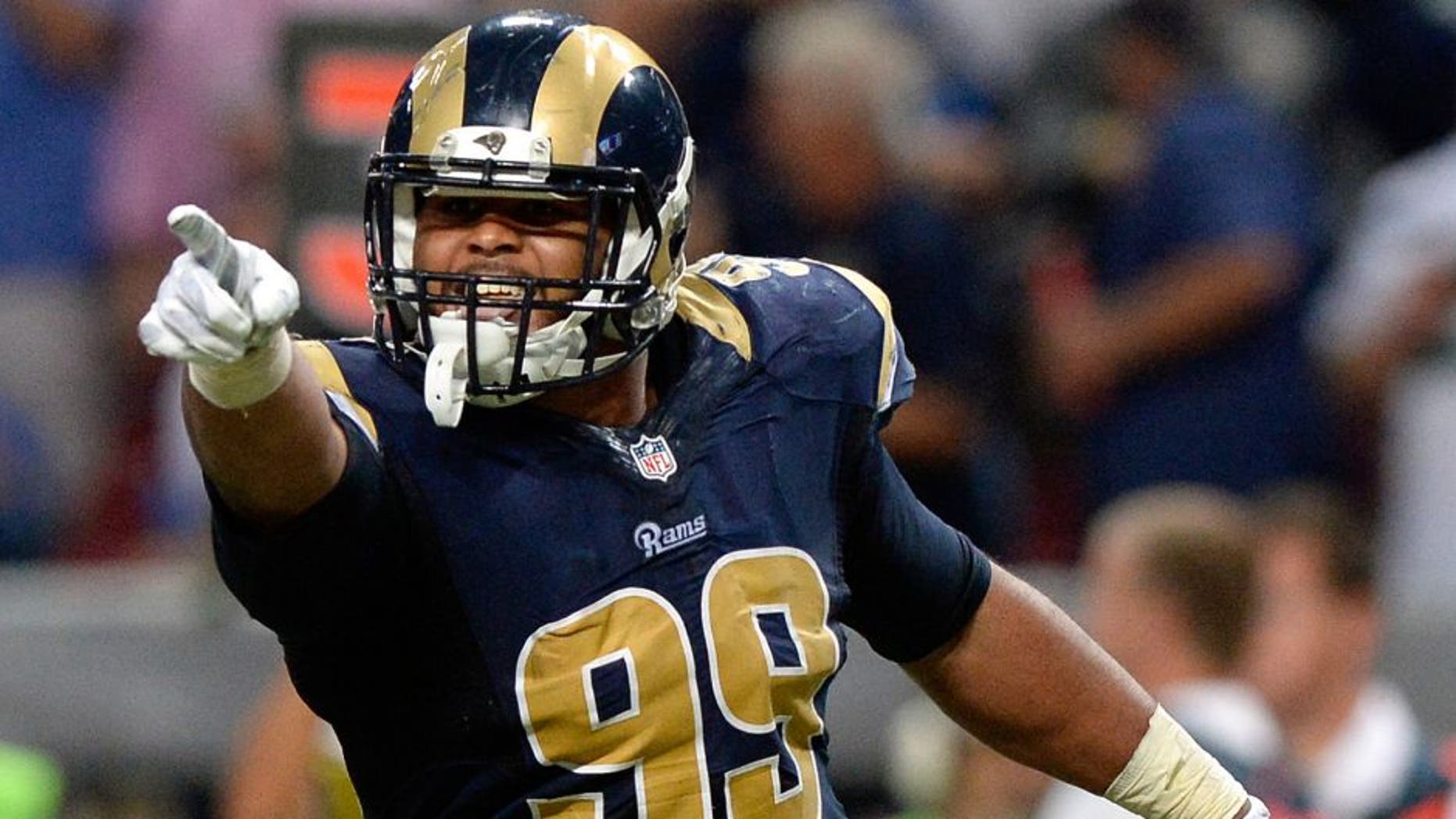 Sep 13, 2015; St. Louis, MO, USA; St. Louis Rams defensive tackle Aaron Donald (99) celebrates after sacking Seattle Seahawks quarterback Russell Wilson (not pictured) during the second half at the Edward Jones Dome. The Rams defeated the Seahawks 34-31 in overtime. Mandatory Credit: Jeff Curry-USA TODAY Sports