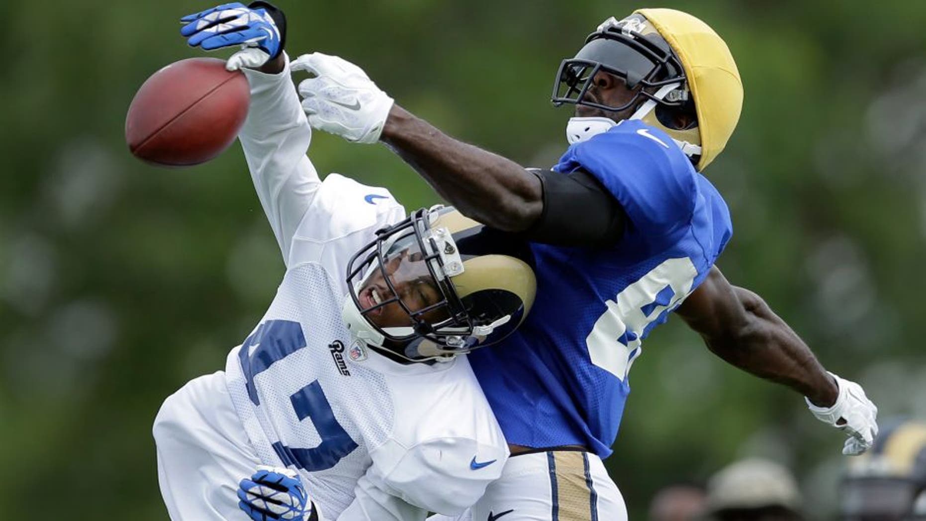 St. Louis Rams cornerback Marcus Roberson, left, knocks a pass away from wide receiver Brian Quick during training camp at the NFL football team's practice facility Tuesday, Aug. 4, 2015, in St. Louis. (AP Photo/Jeff Roberson)