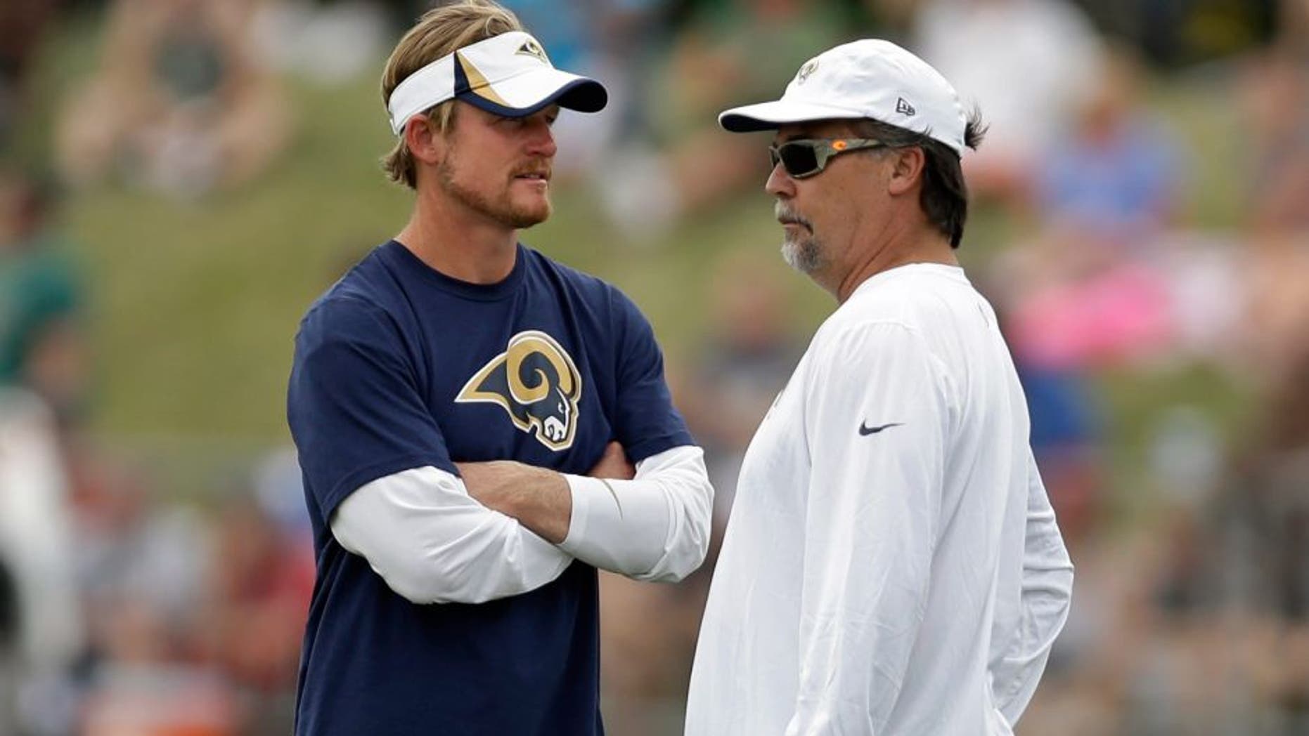 St. Louis Rams head coach Jeff Fisher, right, talks with Rams general manager Les Snead during training camp at the NFL football team's practice facility on Saturday, July 26, 2014, in St. Louis. (AP Photo/Jeff Roberson)