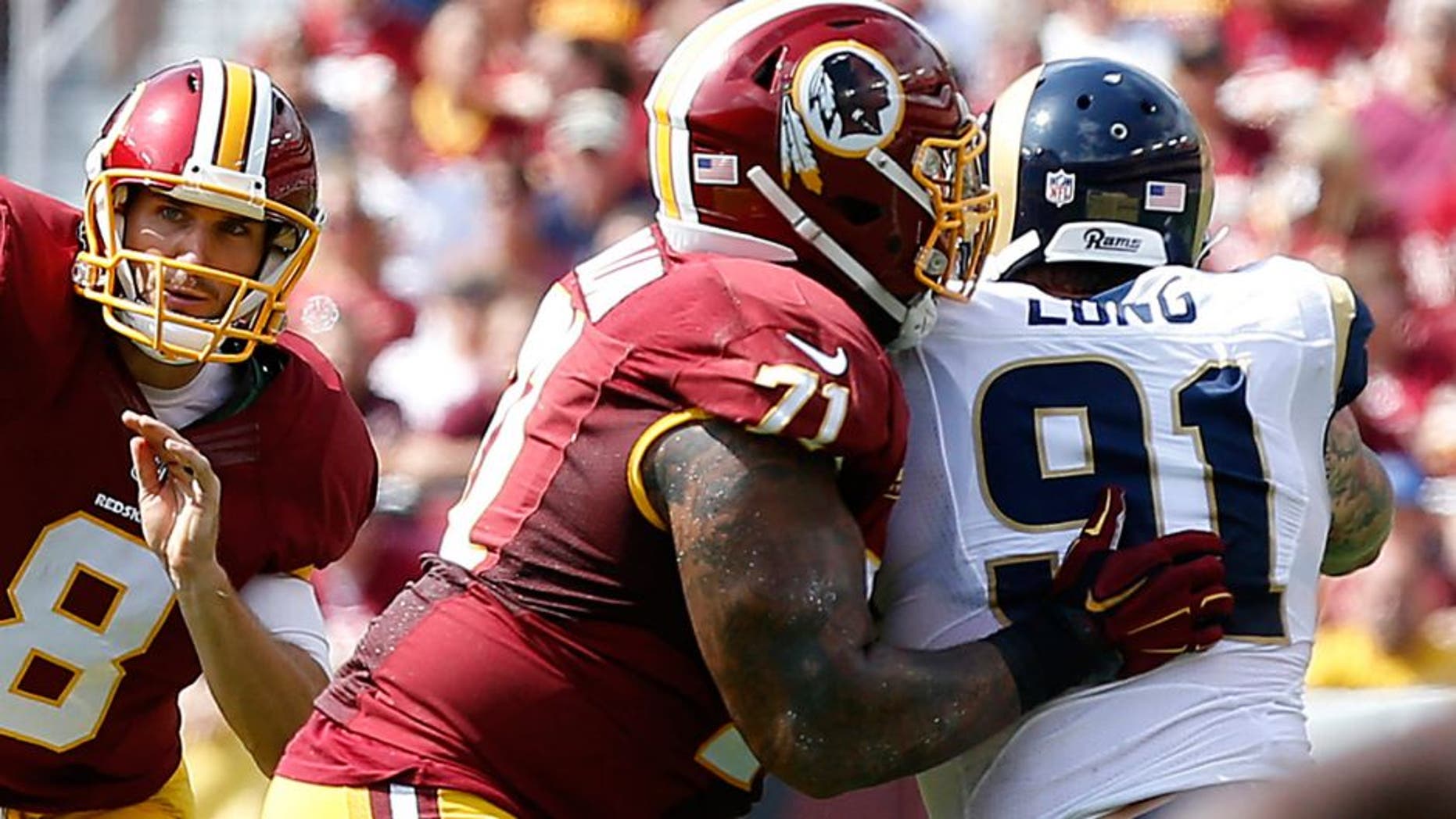 Sep 20, 2015; Landover, MD, USA; Washington Redskins quarterback Kirk Cousins (8) throws the ball as St. Louis Rams defensive end Chris Long (91) chases in the first quarter at FedEx Field. Mandatory Credit: Geoff Burke-USA TODAY Sports