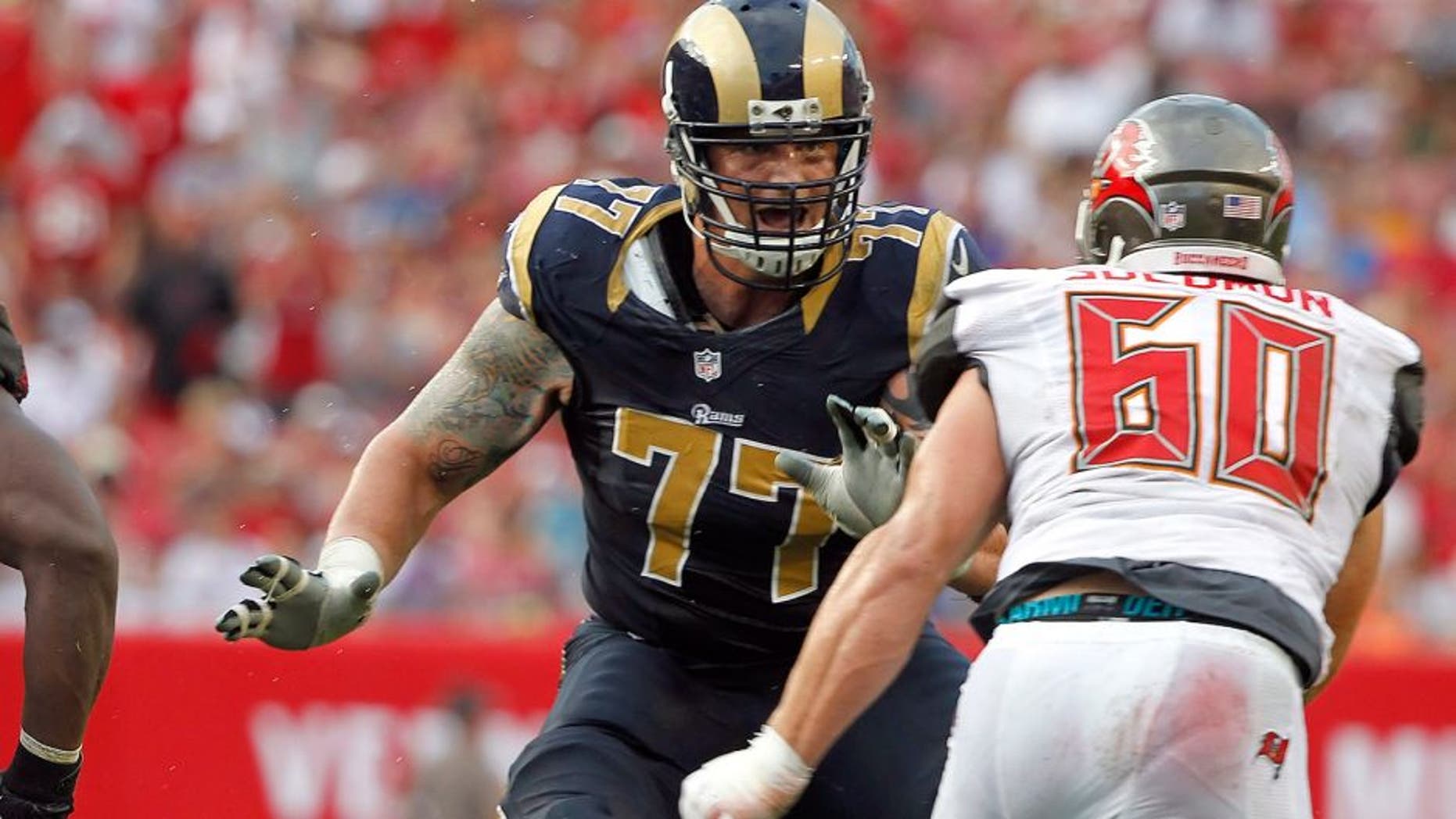 Sep 14, 2014; Tampa, FL, USA; St. Louis Rams tackle Jake Long (77) blocks against the Tampa Bay Buccaneers during the second half at Raymond James Stadium. St. Louis Rams defeated the Tampa Bay Buccaneers 19-17. Mandatory Credit: Kim Klement-USA TODAY Sports