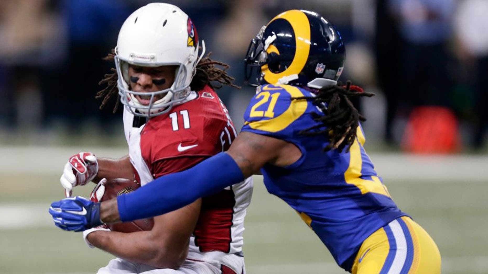 Arizona Cardinals wide receiver Larry Fitzgerald, left, catches a 15-yard pass as St. Louis Rams cornerback Janoris Jenkins defends during the second quarter of an NFL football game on Sunday, Dec. 6, 2015, in St. Louis. (AP Photo/Tom Gannam)