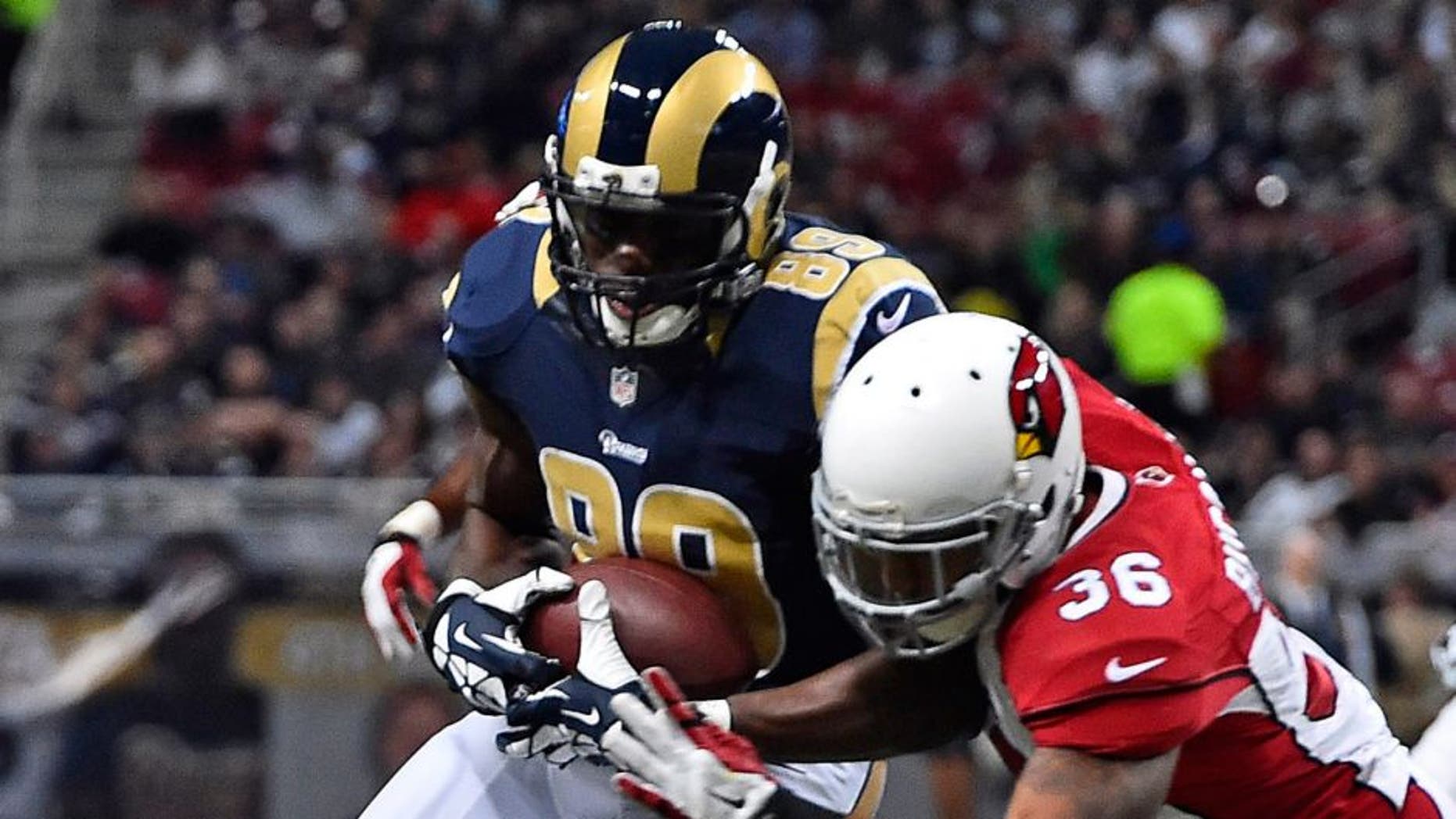 Dec 11, 2014; St. Louis, MO, USA; Arizona Cardinals strong safety Deone Bucannon (36) brings down St. Louis Rams tight end Jared Cook (89) during the first half at the Edward Jones Dome. Mandatory Credit: Jasen Vinlove-USA TODAY Sports