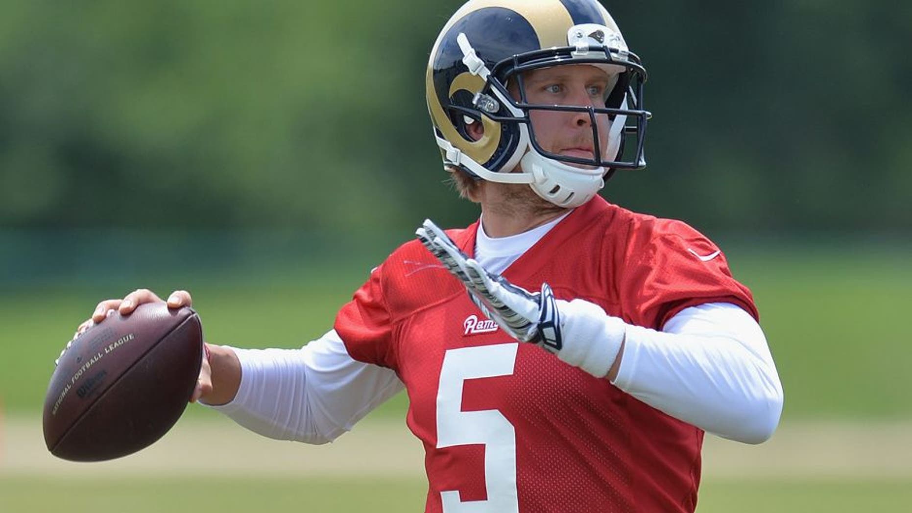 St. Louis Rams quarterback Nick Foles throws a pass during an NFL football organized team activity, Thursday, June 11, 2015, in St. Louis. (AP Photo/Michael Thomas)