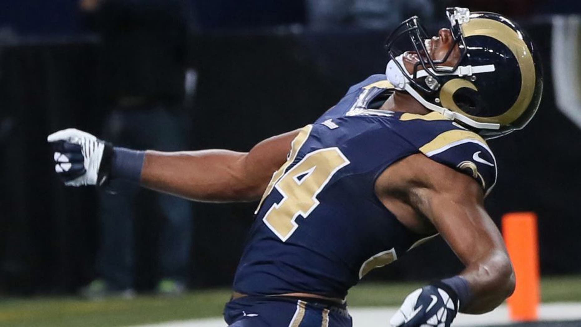 Oct 28, 2013; St. Louis, MO, USA; St. Louis Rams defensive end Robert Quinn (94) celebrates after sacking Seattle Seahawks quarterback Russell Wilson (not pictured) during the first quarter at Edward Jones Dome. Mandatory Credit: Nelson Chenault-USA TODAY Sports