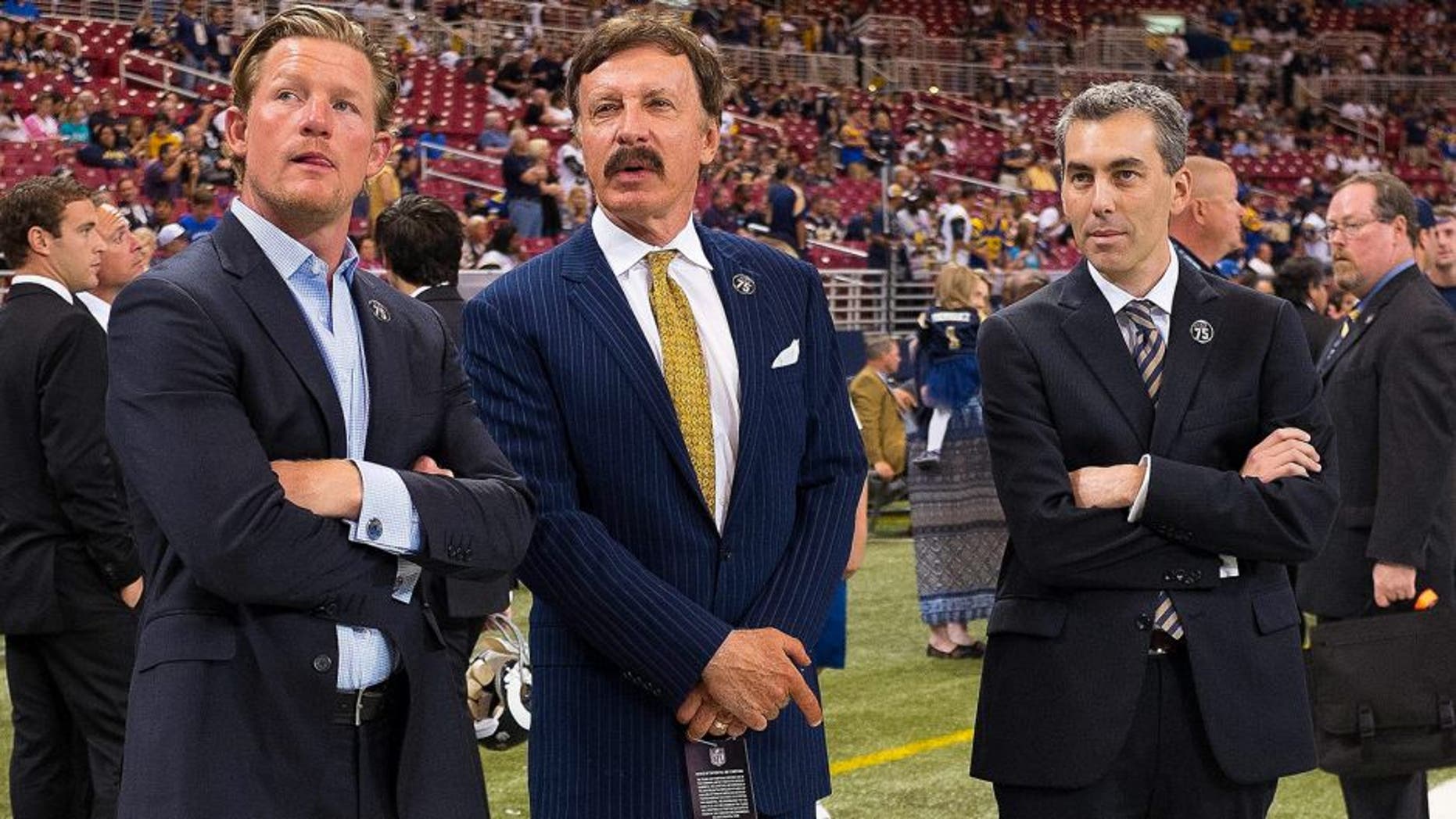 Sep 8, 2013; St. Louis, MO, USA; St. Louis Rams owner Stan Kroenke (M) talks with general manager Les Snead (L) and president Kevin Demoff before the game against the Arizona Cardinals at Edward Jones Dome. Mandatory Credit: Scott Rovak-USA TODAY Sports