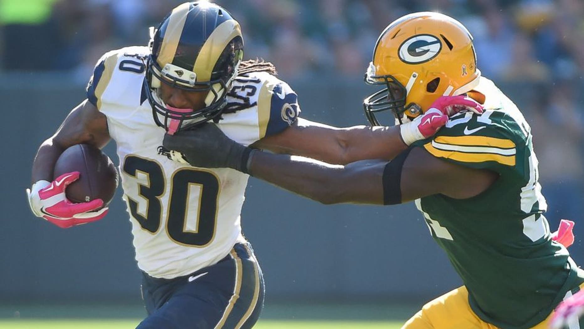Oct 11, 2015; Green Bay, WI, USA; St. Louis Rams running back Todd Gurley (30) pushes away Green Bay Packers linebacker Nate Palmer (51) in the third quarter at Lambeau Field. Mandatory Credit: Benny Sieu-USA TODAY Sports