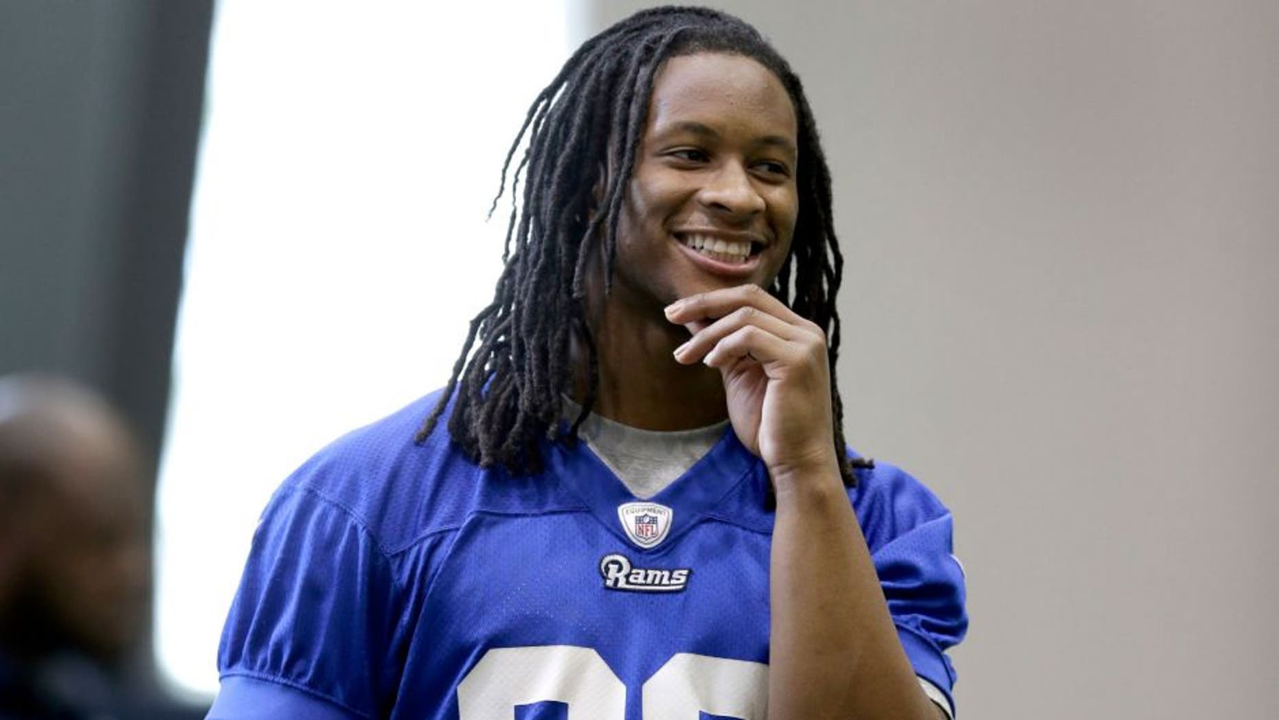 St Louis Rams first-round draft pick, running back Todd Gurley, smiles as he stands on the sideline during a rookie minicamp at the NFL football team's practice facility Friday, May 8, 2015, in St. Louis. (AP Photo/Jeff Roberson)