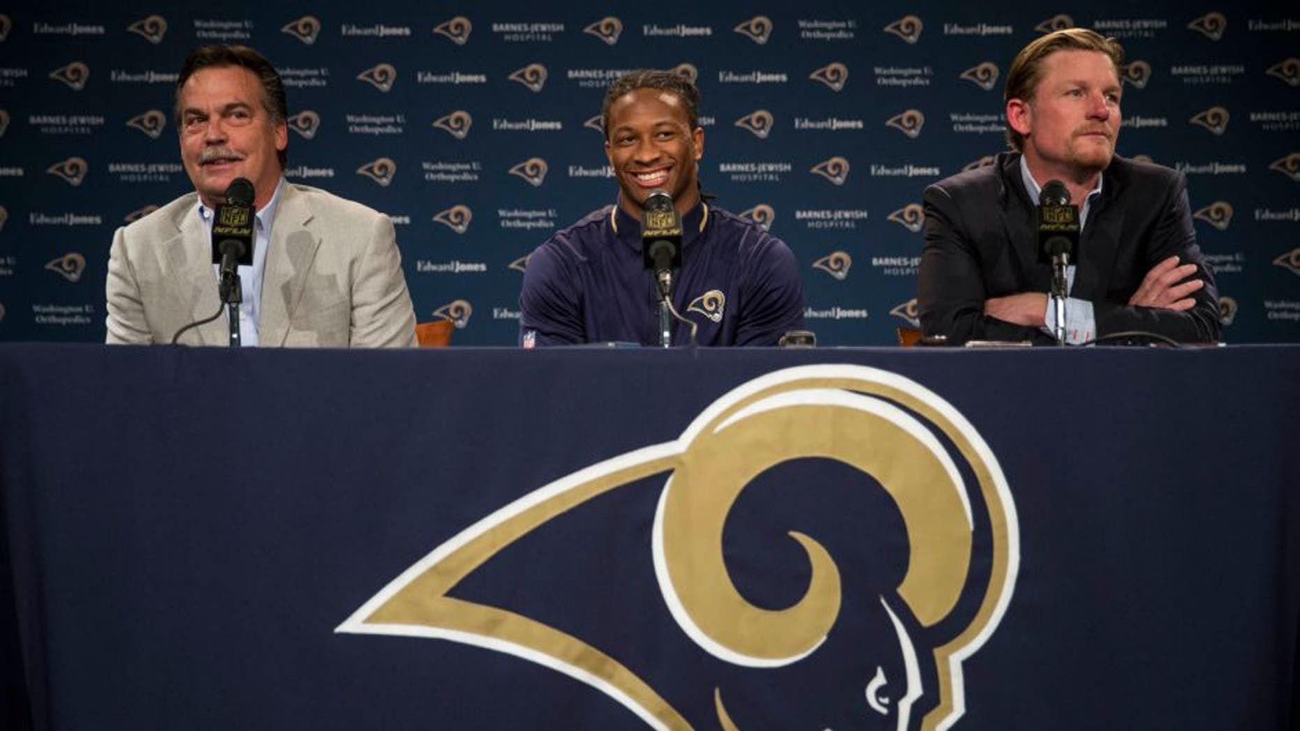 St. Louis Rams head coach Jeff Fisher, left, and general manager Les Snead, right, introduce first-round draft pick Todd Gurley during a news conference at the NFL football team's practice facility Friday, May 1, 2015, in St. Louis. Gurley, a running back from Georgia, was picked tenth overall by the Rams. (AP Photo/Whitney Curtis)