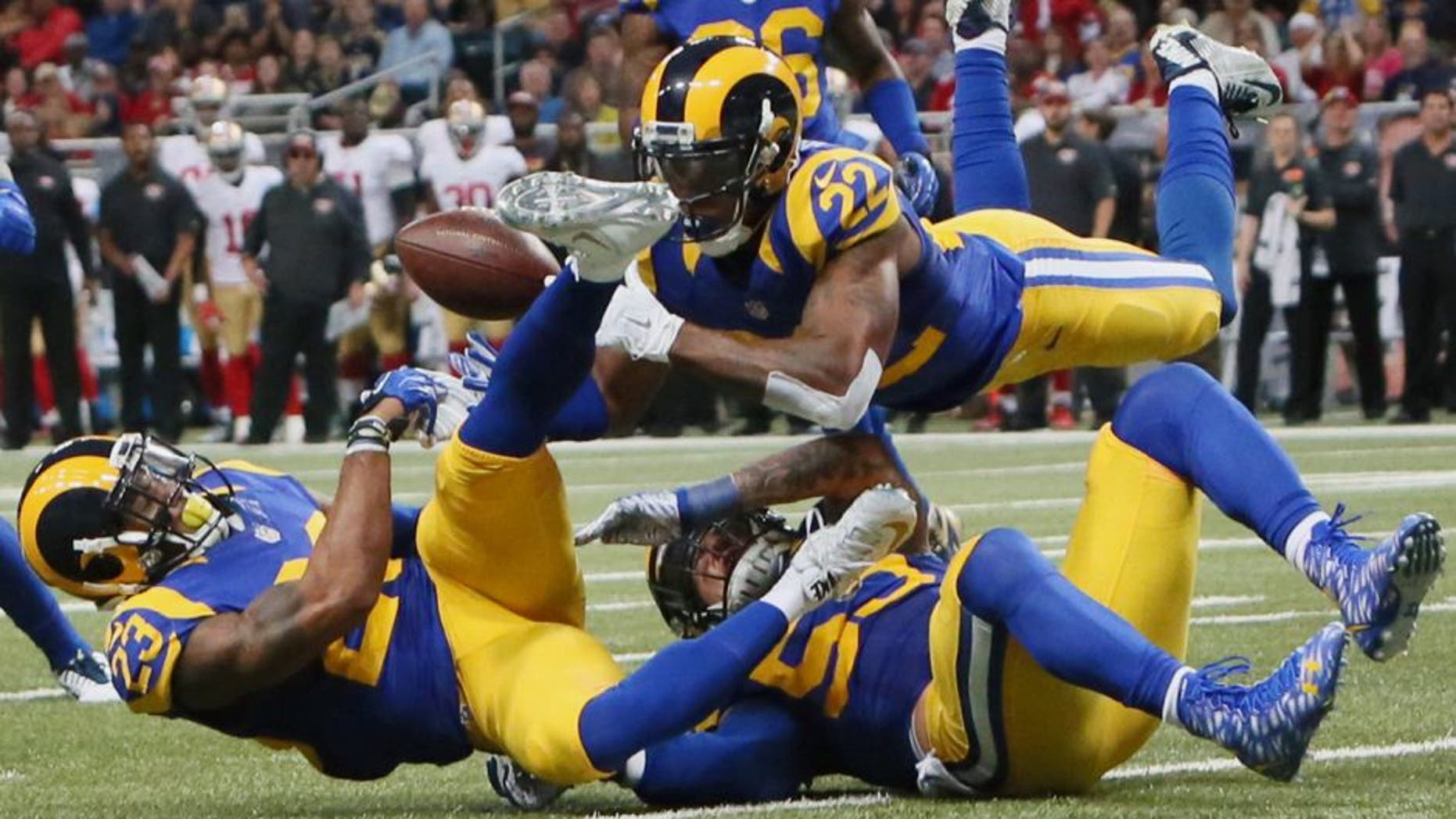 St. Louis Rams' Rodney McLeod, cornerback Trumaine Johnson (22) and linebacker James Laurinaitis converge on a pass but are unable to make an interception during an NFL football game against the San Francisco 49ers Sunday, Nov. 1, 2015, in St. Louis. (Chris Lee/St. Louis Post-Dispatch via AP) EDWARDSVILLE INTELLIGENCER OUT; THE ALTON TELEGRAPH OUT; MANDATORY CREDIT