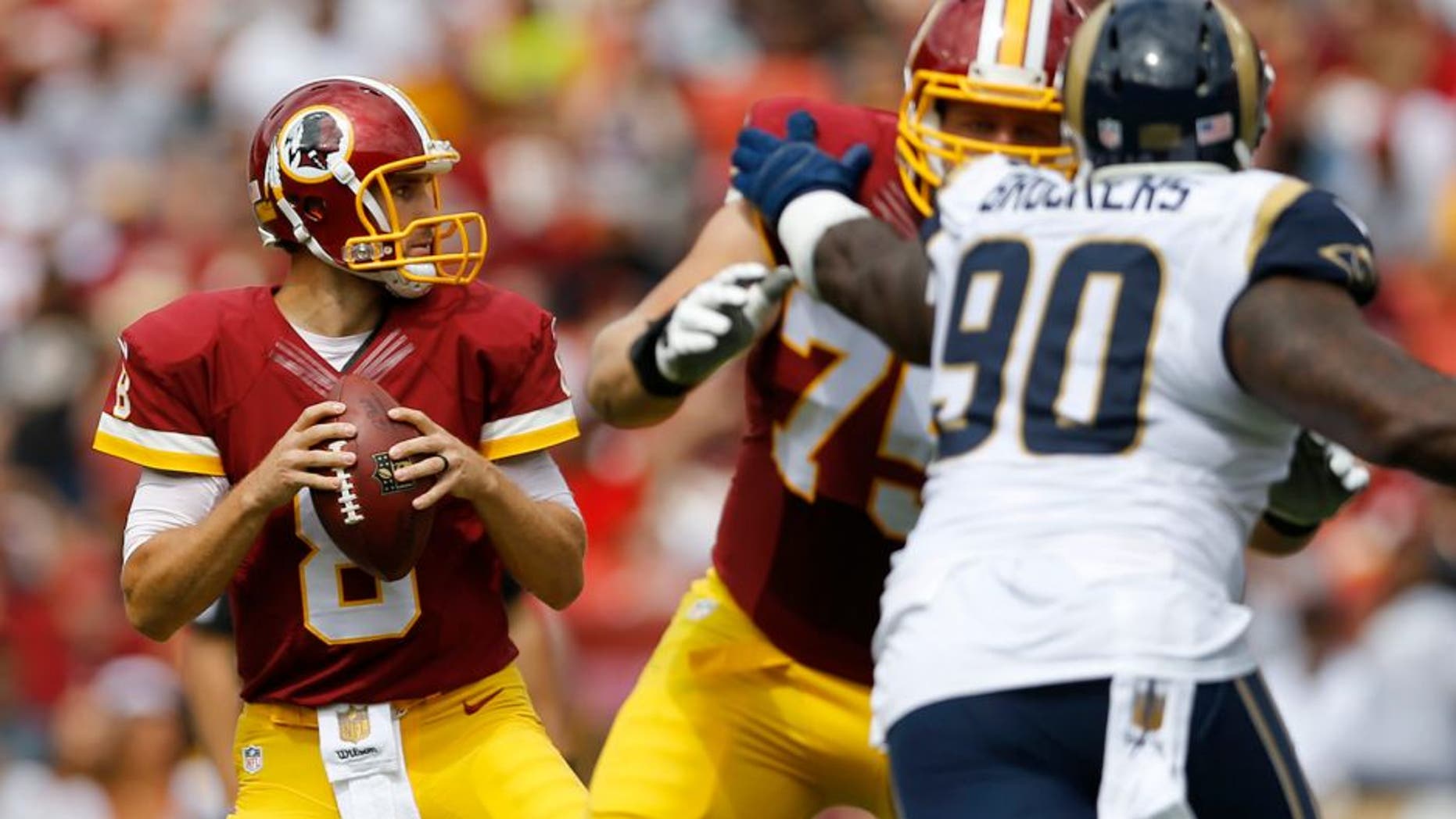 Washington Redskins quarterback Kirk Cousins (8) looks for an opening to pass during the first half of an NFL football game against the St. Louis Rams in Landover, Md., Sunday, Sept. 20, 2015. (AP Photo/Patrick Semansky)