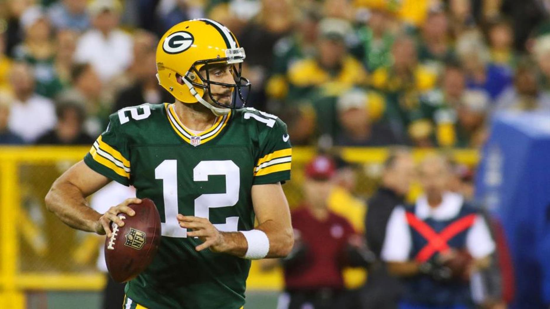 Green Bay Packers quarterback Aaron Rodgers looks to pass against the Seattle Seahawks during the first quarter at Lambeau Field on Sunday, Sept. 20, 2015.