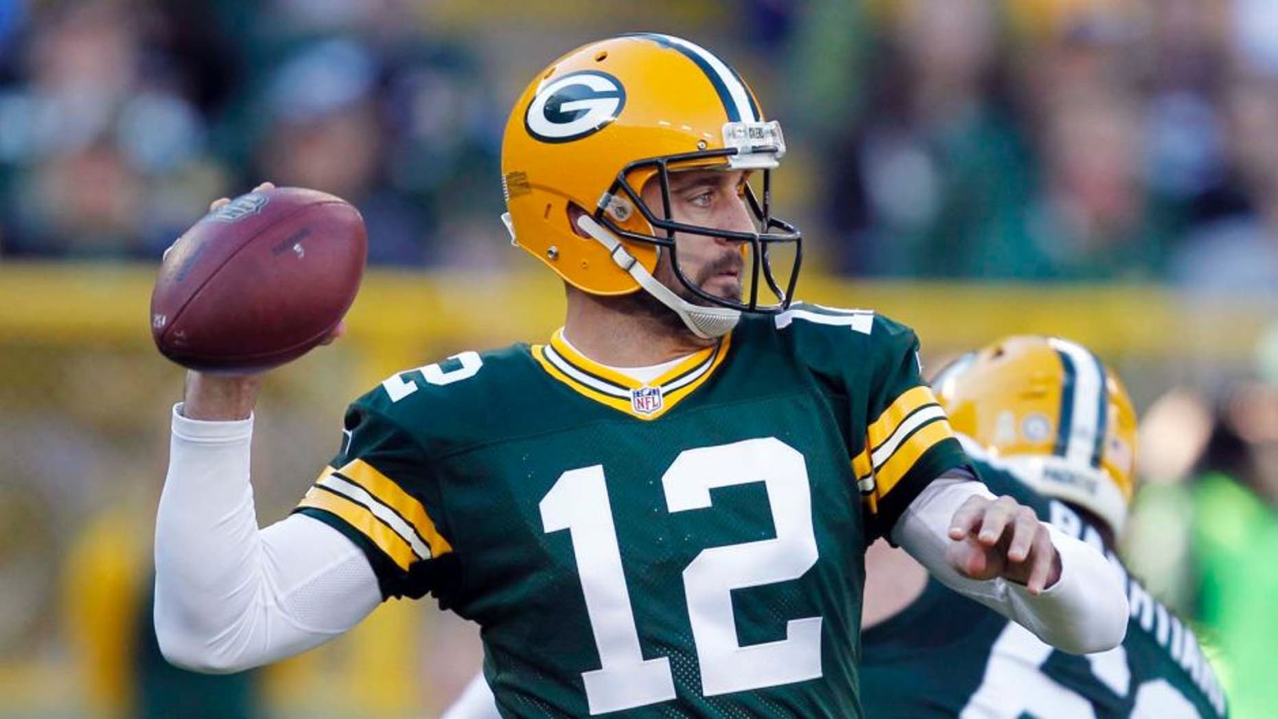 The Green Bay Packers' Aaron Rodgers throws during the first half of an NFL football game against the Detroit Lions on Sunday, Nov. 15, 2015, in Green Bay, Wis.