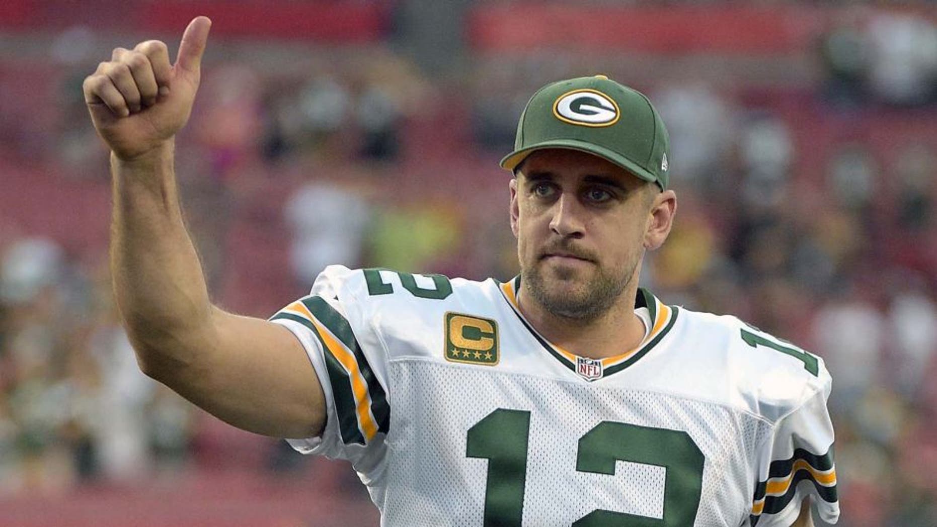 Green Bay Packers quarterback Aaron Rodgers gives the thumbs up to fans as he leaves the field following the team's 20-3 win over the Tampa Bay Buccaneers.