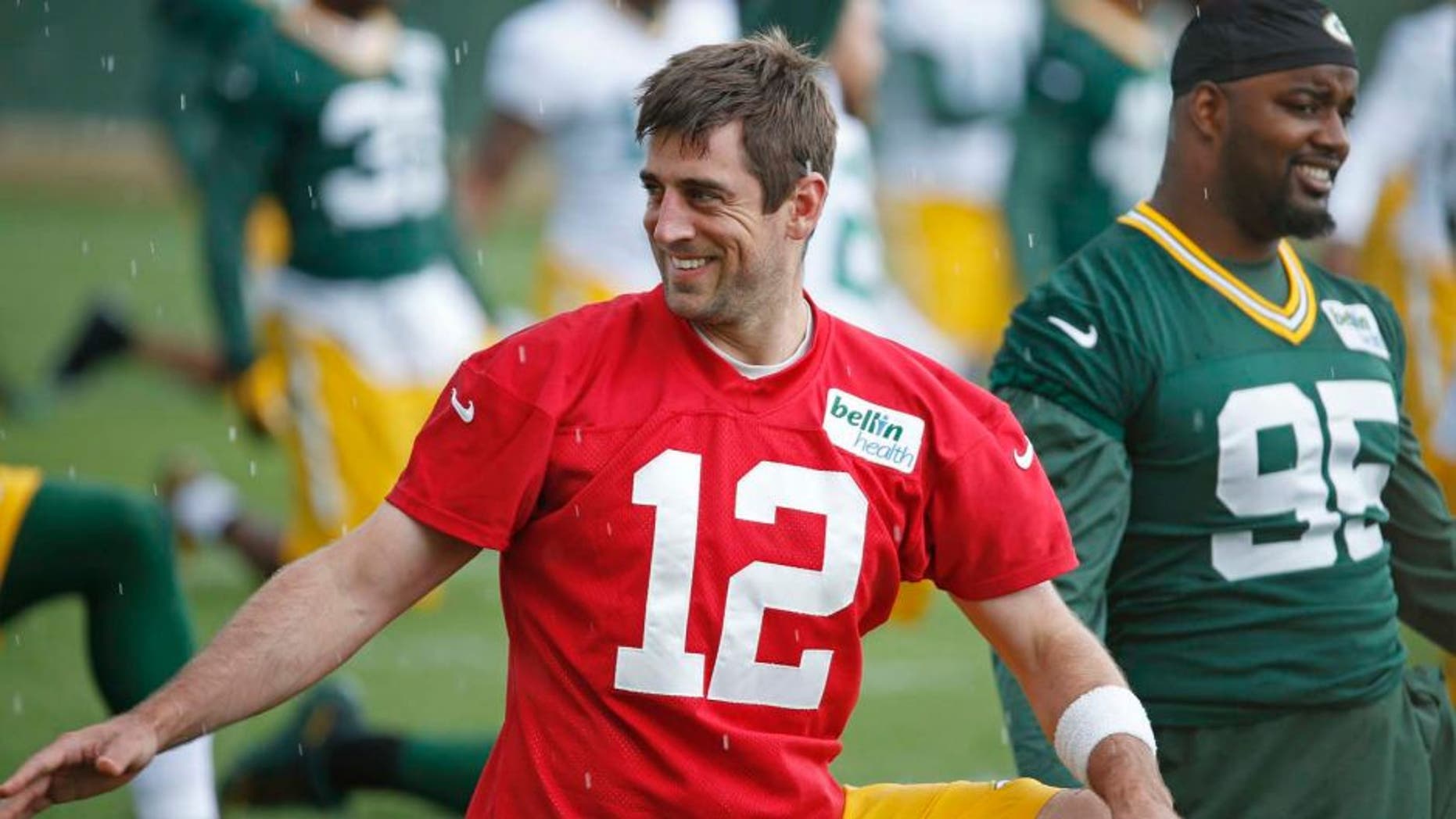 Green Bay Packers quarterback Aaron Rodgers stretches during a practice Monday June 6, 2016, in Green Bay, Wis.