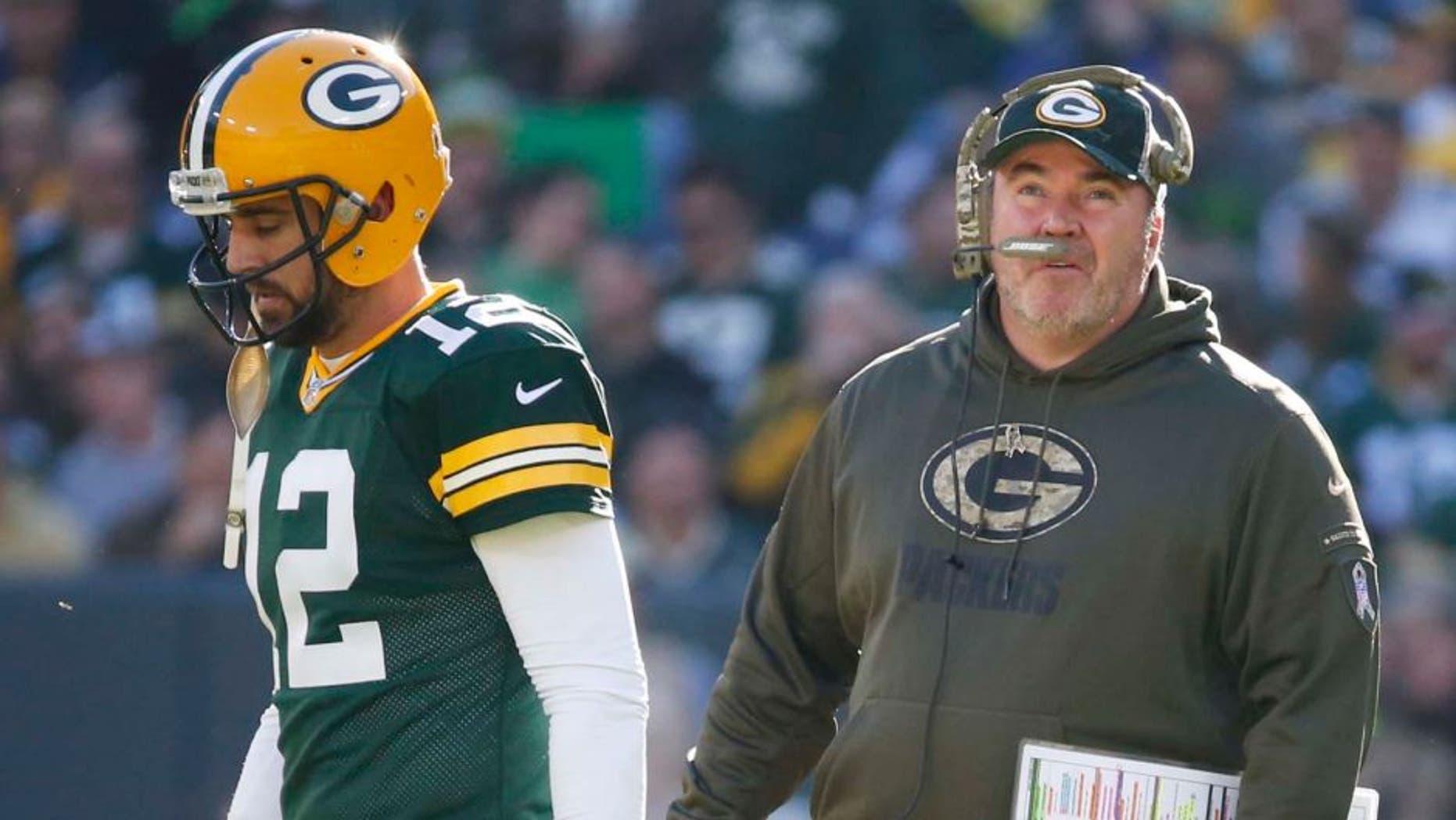 Green Bay Packers head coach Mike McCarthy talks to quarterback Aaron Rodgers during the first half of an NFL football game against the Detroit Lions on Sunday, Nov. 15, 2015, in Green Bay, Wis.