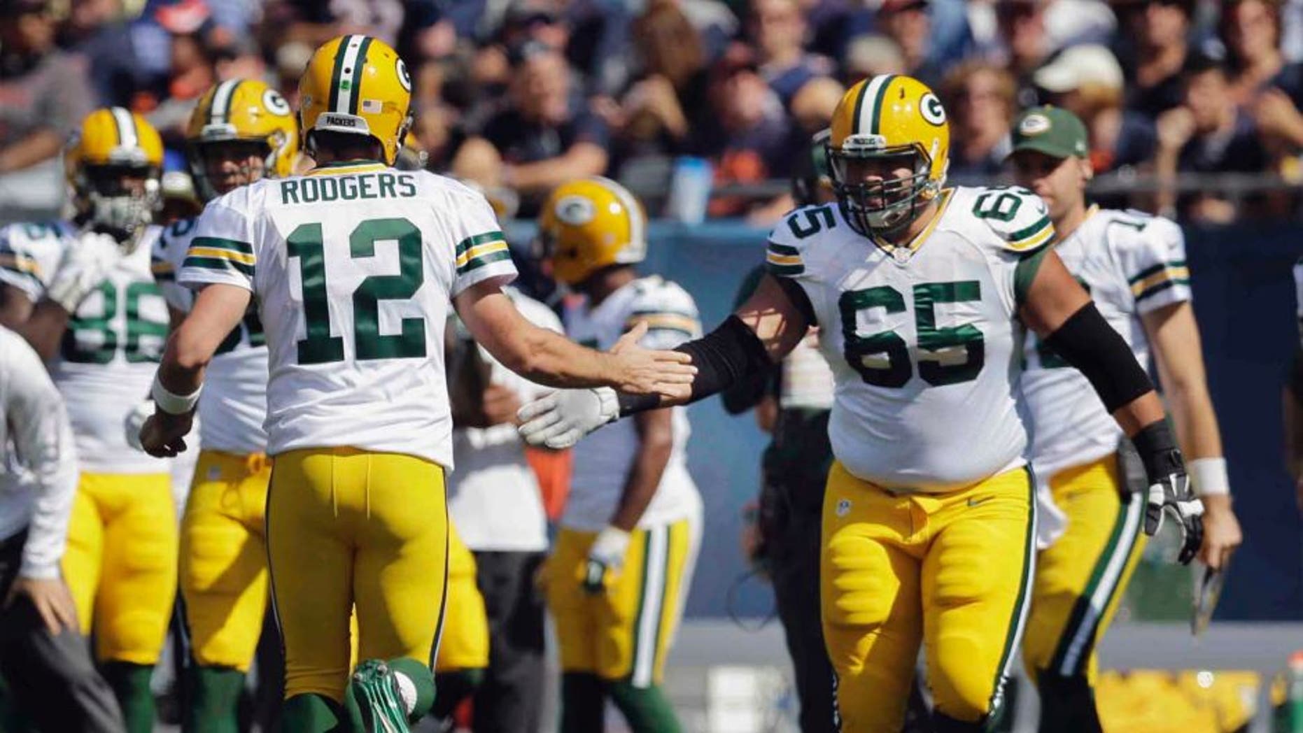 Green Bay Packers quarterback Aaron Rodgers (left) celebrates with guard Lane Taylor after throwing a touchdown pass in the first half.