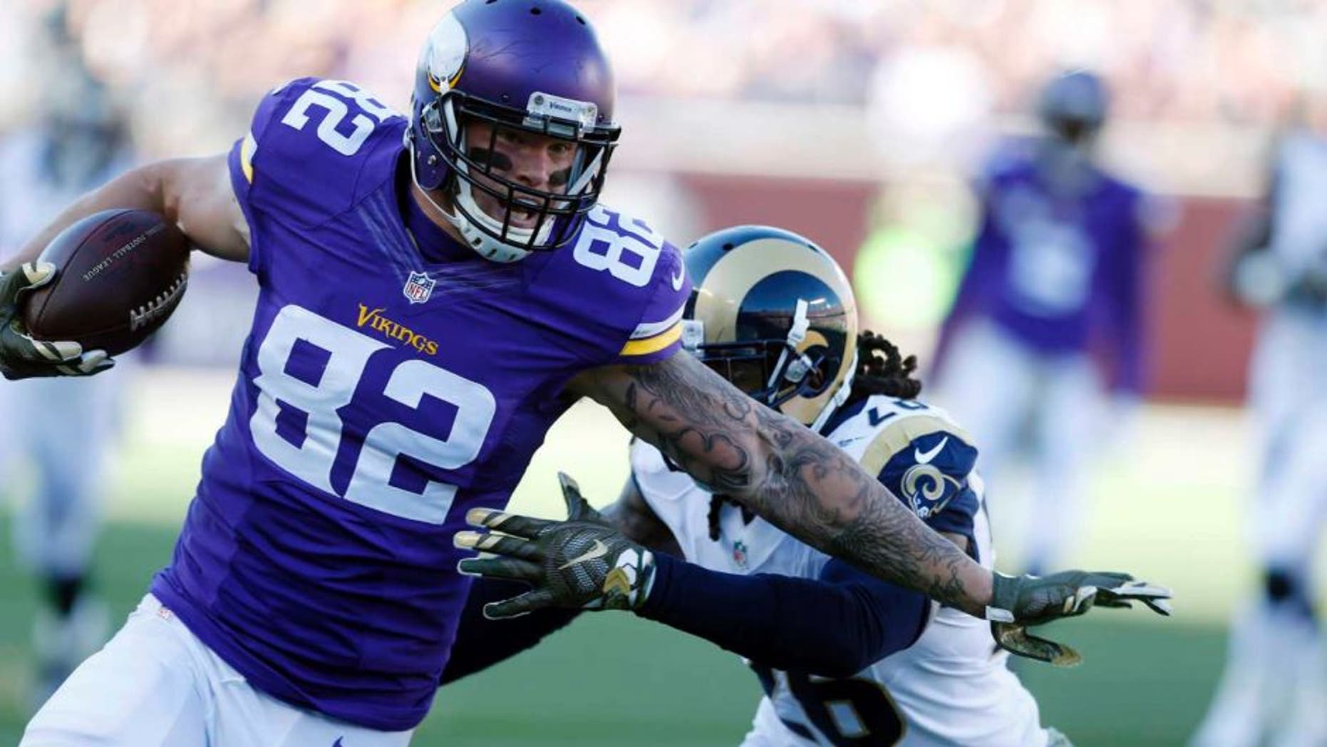 Minnesota Vikings tight end Kyle Rudolph is pulled down by St. Louis Rams outside linebacker Mark Barron during the first half on Sunday, Nov. 8, 2015, in Minneapolis.