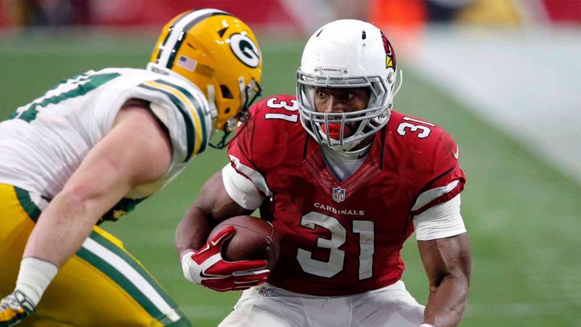 Arizona Cardinals running back David Johnson tries to elude Green Bay Packers outside linebacker Jake Ryan during the first half Sunday, Dec. 27, 2015, in Glendale, Ariz.