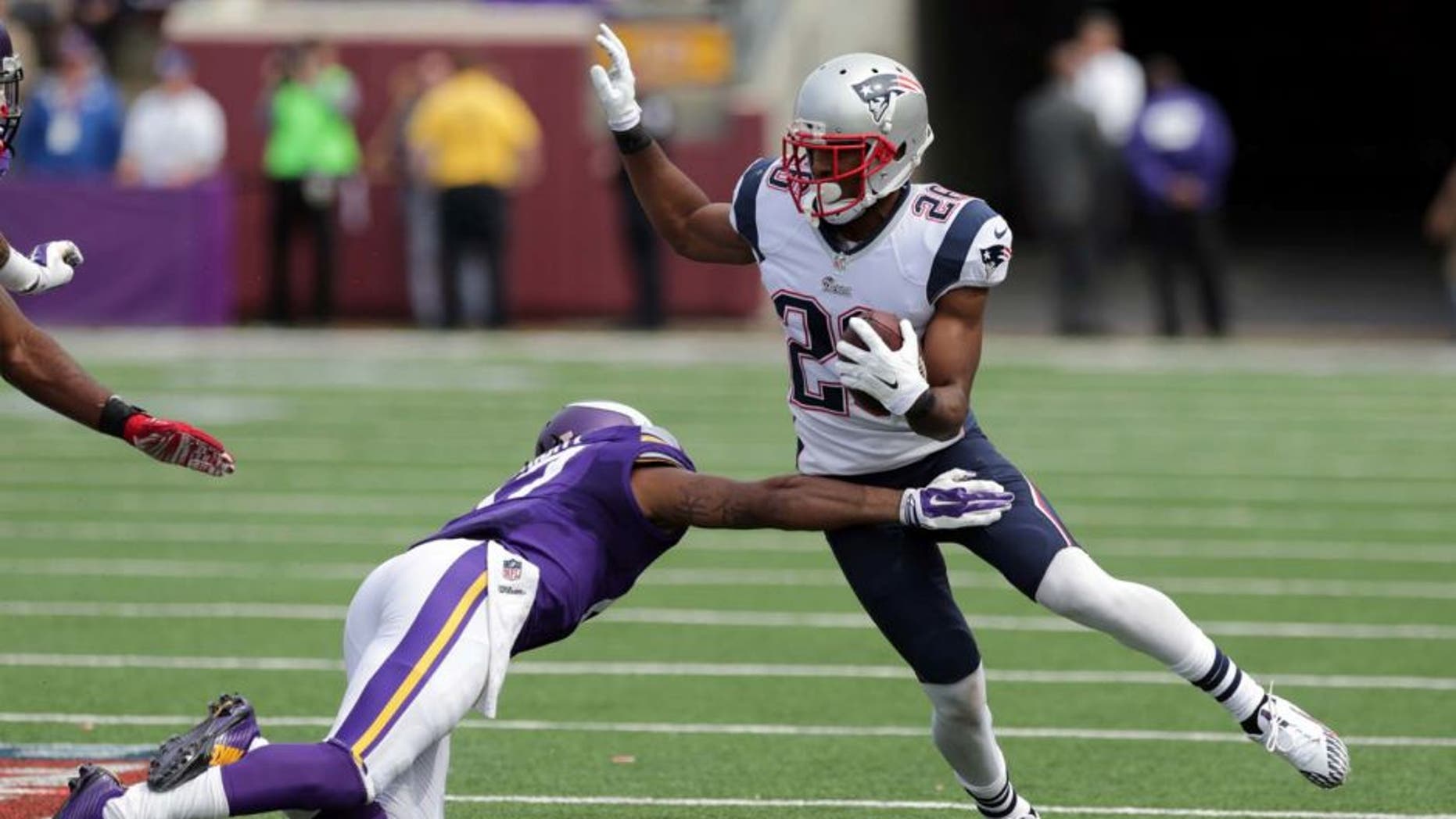 New England Patriots cornerback Logan Ryan (right) tries to avoid Minnesota Vikings wide receiver Jarius Wright after intercepting a pass during the third quarter.