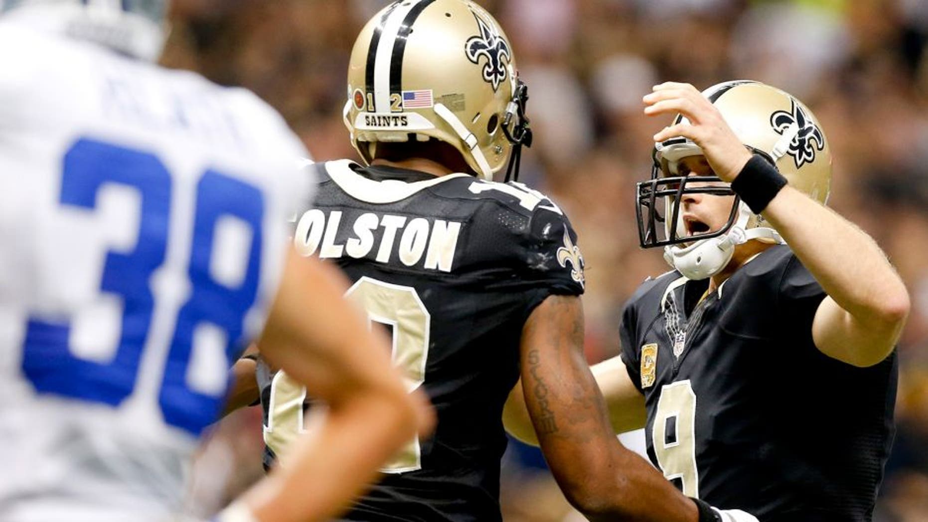 Nov 10, 2013; New Orleans, LA, USA; New Orleans Saints quarterback Drew Brees (9) celebrates with wide receiver Marques Colston (12) after a touchdown during the first quarter of a game against the Dallas Cowboys at Mercedes-Benz Superdome. Mandatory Credit: Derick E. Hingle-USA TODAY Sports