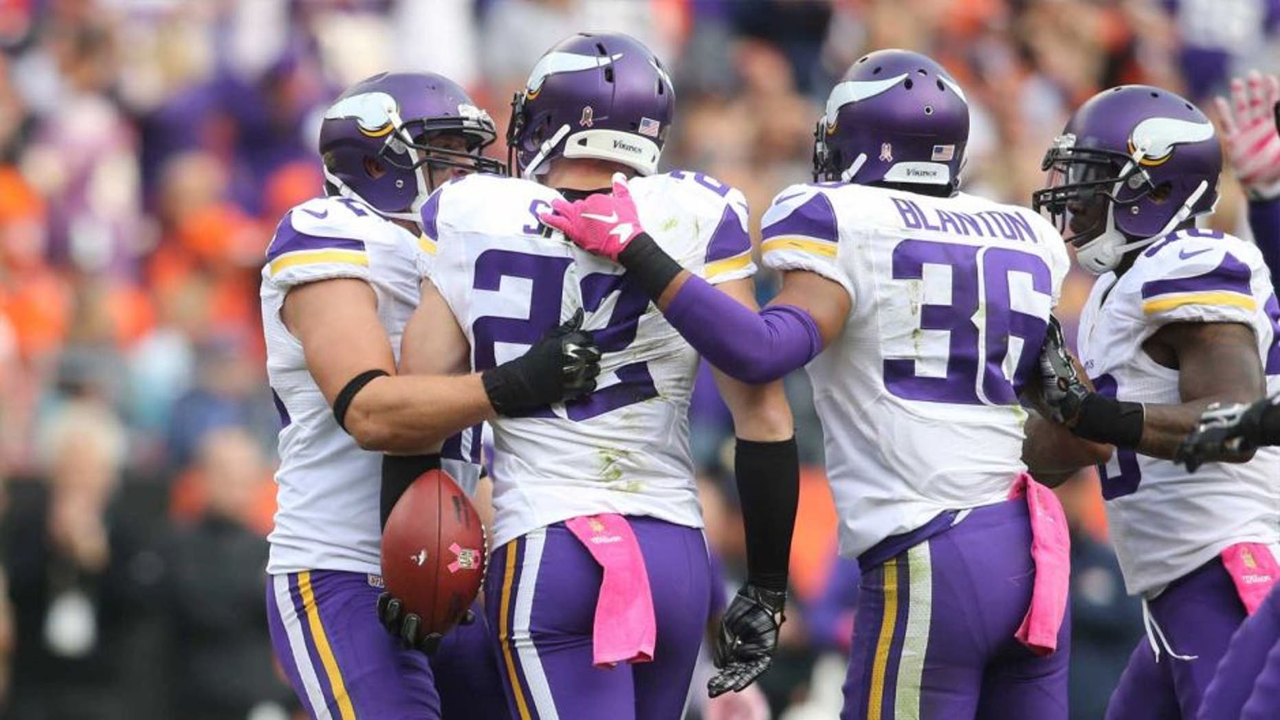 Minnesota Vikings free safety Harrison Smith celebrates with teammates after intercepting a pass intended for Denver Broncos wide receiver Demaryius Thomas during the second half at Sports Authority Field at Mile High in Denver on Sunday, Oct. 4, 2015.