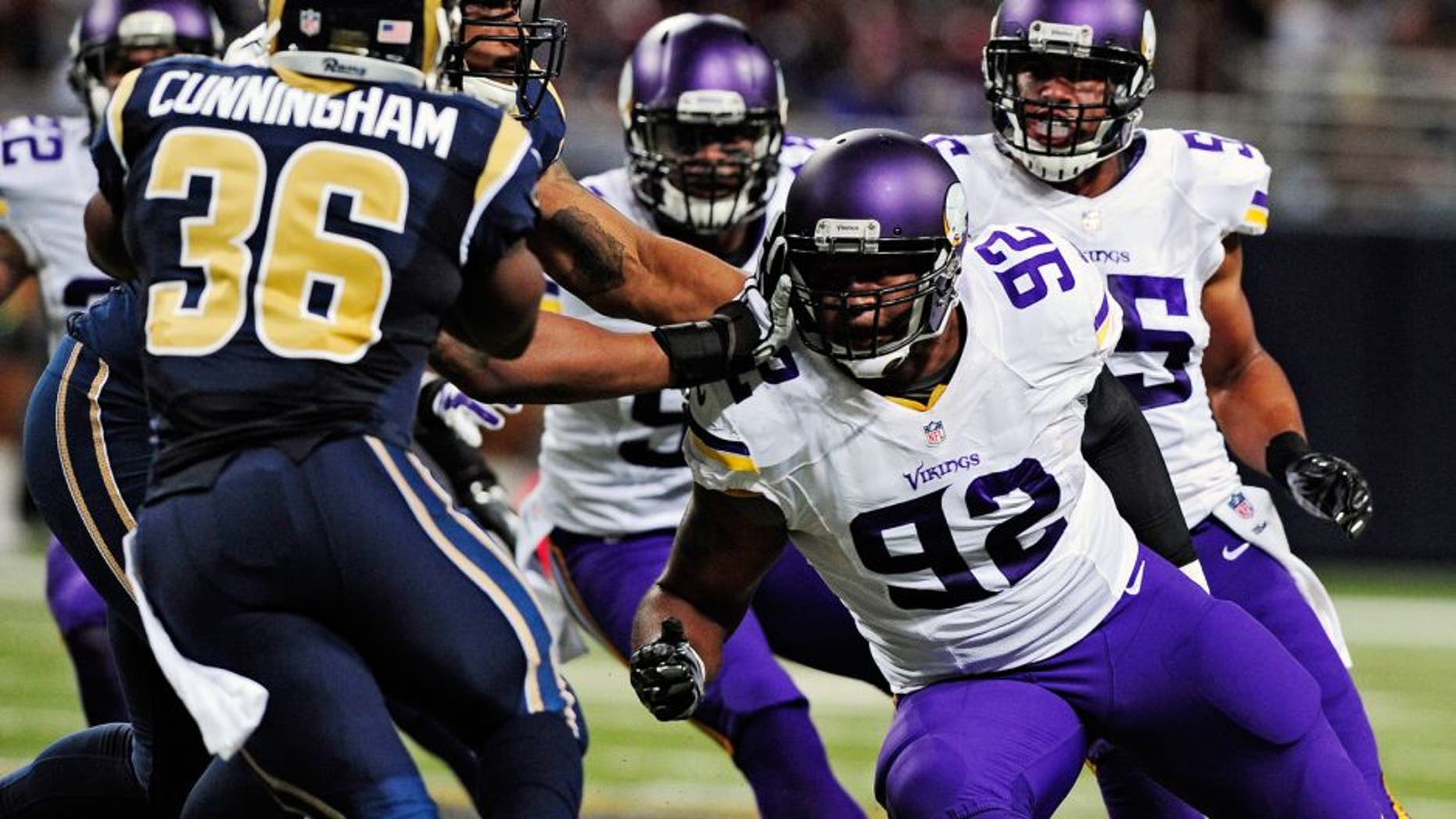 Sep 7, 2014; St. Louis, MO, USA; Minnesota Vikings defensive tackle Tom Johnson (92) defends against St. Louis Rams running back Benny Cunningham (36) during the second half at the Edward Jones Dome. The Vikings defeated the Rams 34-6. Mandatory Credit: Jeff Curry-USA TODAY Sports