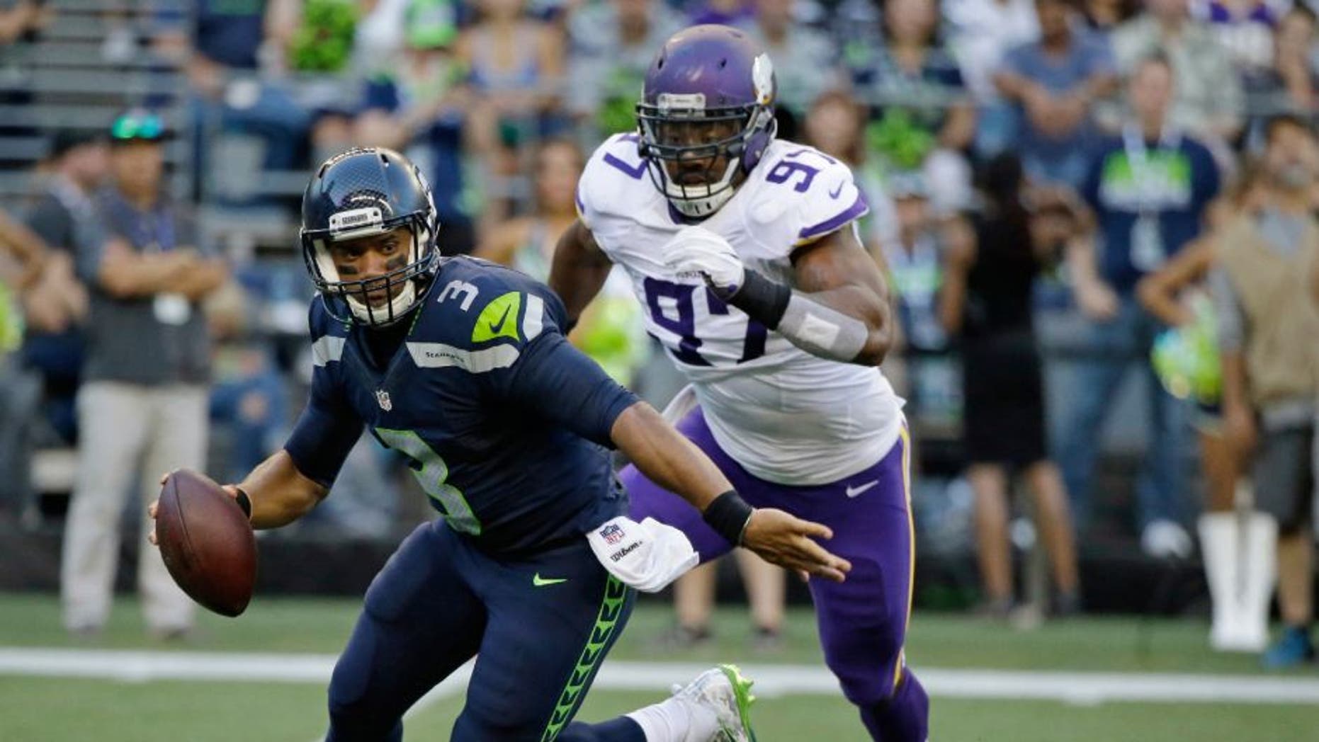 Minnesota Vikings defensive end Everson Griffen prepares to sack Seattle Seahawks quarterback Russell Wilson during the first half of a preseason NFL football game, Thursday, Aug. 18, 2016, in Seattle.
