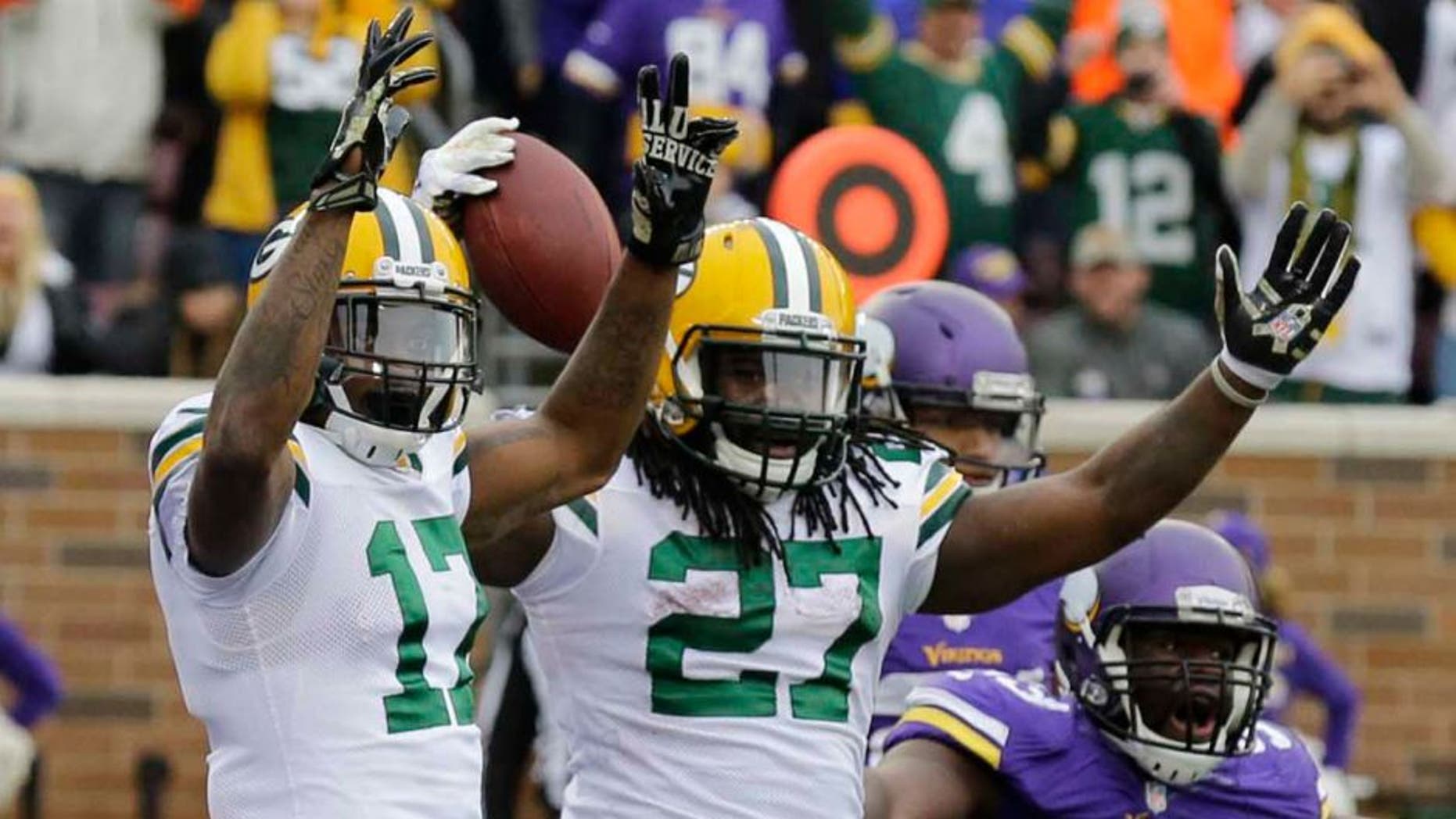 Sunday, November 23: Green Bay Packers running back Eddie Lacy (center) celebrates with teammate Davante Adams (left) after scoring on a 10-yard touchdown reception during the second half. Minnesota Vikings defensive tackle Shamar Stephen (right) disputes the call.