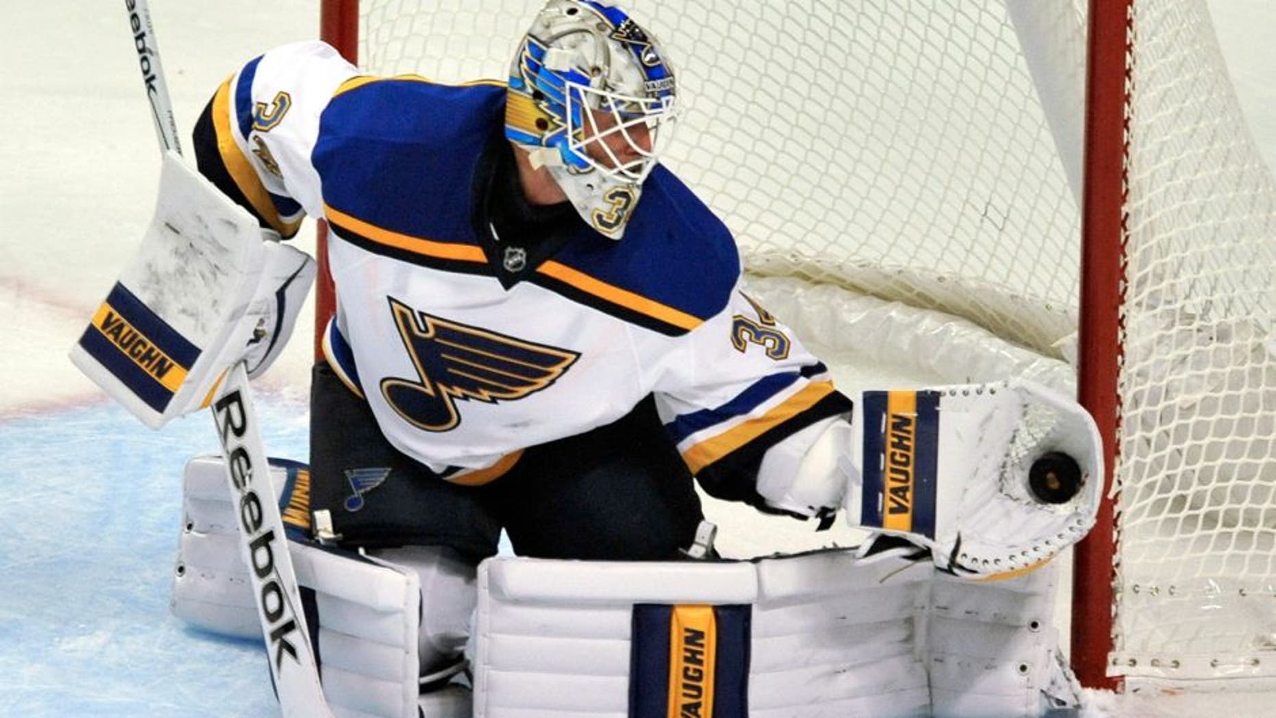 St. Louis Blues goalie Jake Allen (34) makes a save during the second period of a preseason NHL hockey game against the Chicago Blackhawks on Saturday, Sept. 26, 2015, in Chicago. (AP Photo/Paul Beaty)
