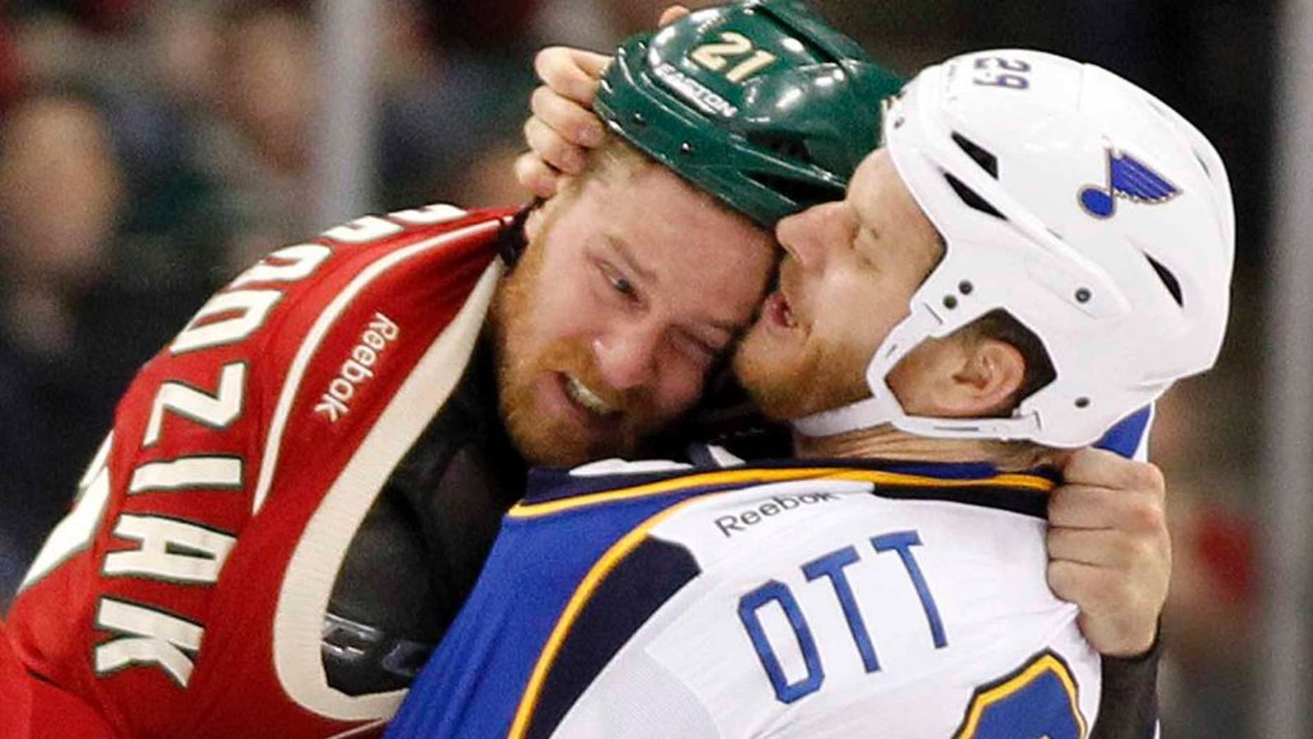 Minnesota Wild center Kyle Brodziak (left) and St. Louis Blues center Steve Ott fight during the first period.
