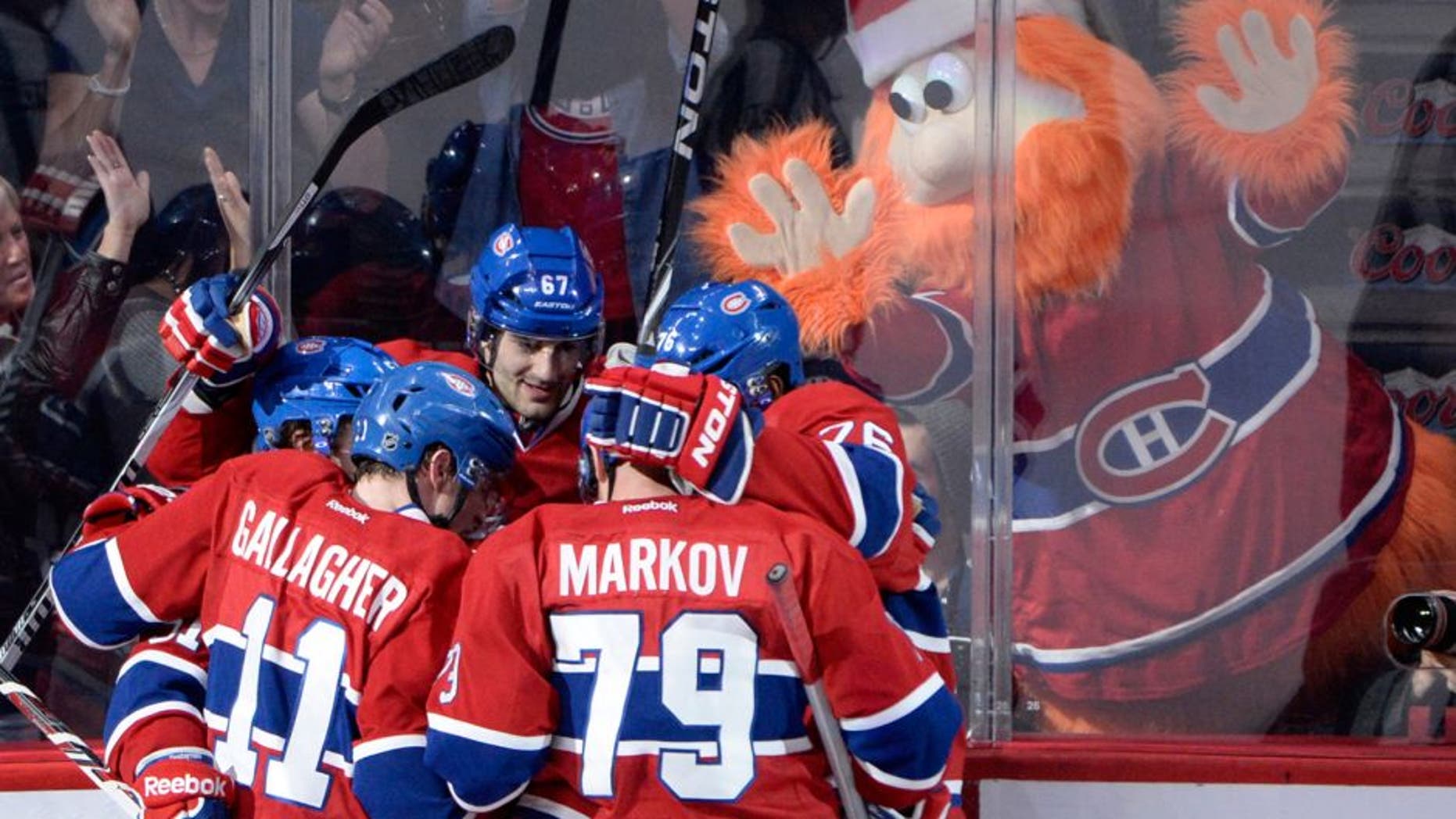 Dec 17, 2013; Montreal, Quebec, CAN; Montreal Canadiens forward Max Pacioretty (67) celebrates with teammates Brendan Gallagher (11) and P.K. Subban (76) and Andrei Markov (79) with team mascot Youppi in the background after scoring a goal against the Phoenix Coyotes during the third period at the Bell Centre. Mandatory Credit: Eric Bolte-USA TODAY Sports