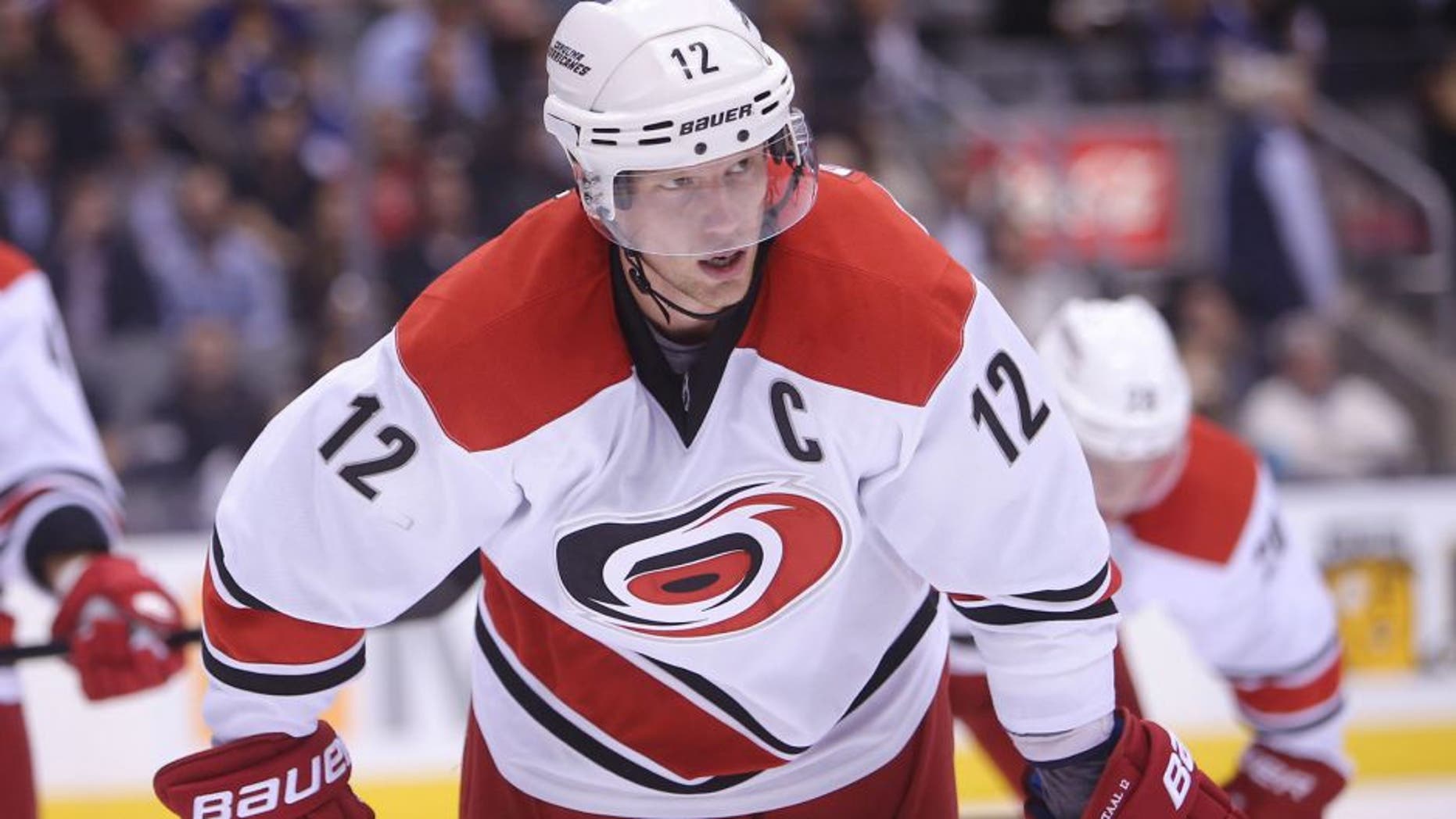 Oct 17, 2013; Toronto, Ontario, CAN; Carolina Hurricanes center Eric Staal (12) before a face-off against the Toronto Maple Leafs at the Air Canada Centre. The Hurricanes beat the Maple Leafs 3-2. Mandatory Credit: Tom Szczerbowski-USA TODAY Sports