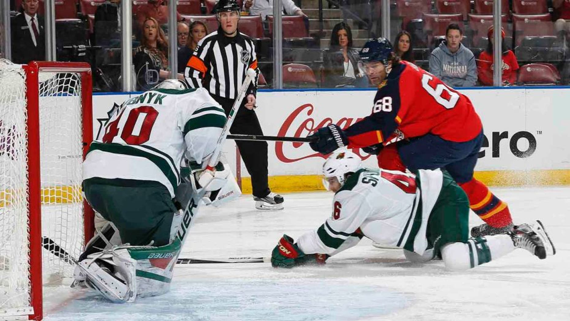 Florida Panthers forward Jaromir Jagr (right) scores a goal past Minnesota Wild goaltender Devan Dubnyk during the first period Sunday, Jan. 3, 2016, in Sunrise, Fla.