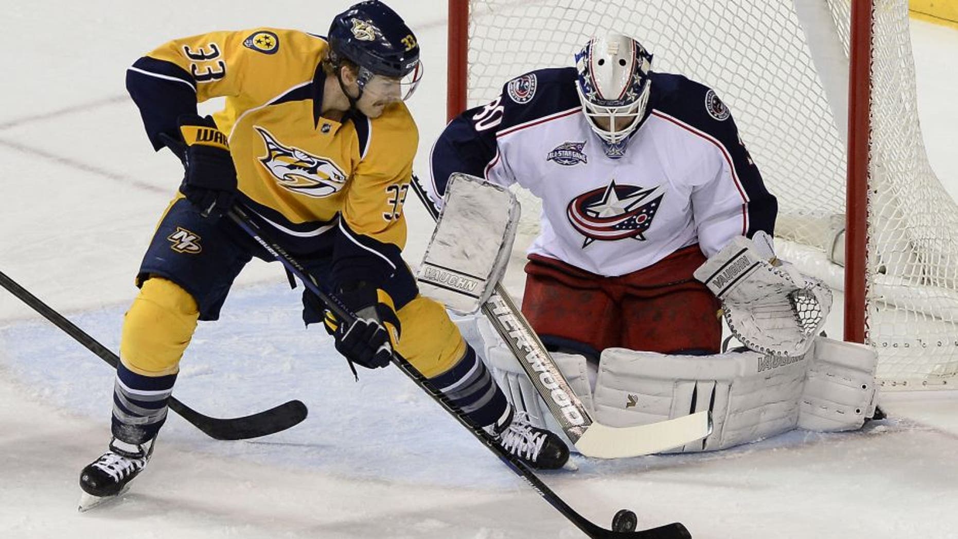Columbus Blue Jackets goalie Curtis McElhinney (30) blocks a shot by Nashville Predators center Colin Wilson (33) in the first period of an NHL hockey game Saturday, Nov. 29, 2014, in Nashville, Tenn. (AP Photo/Mark Zaleski)