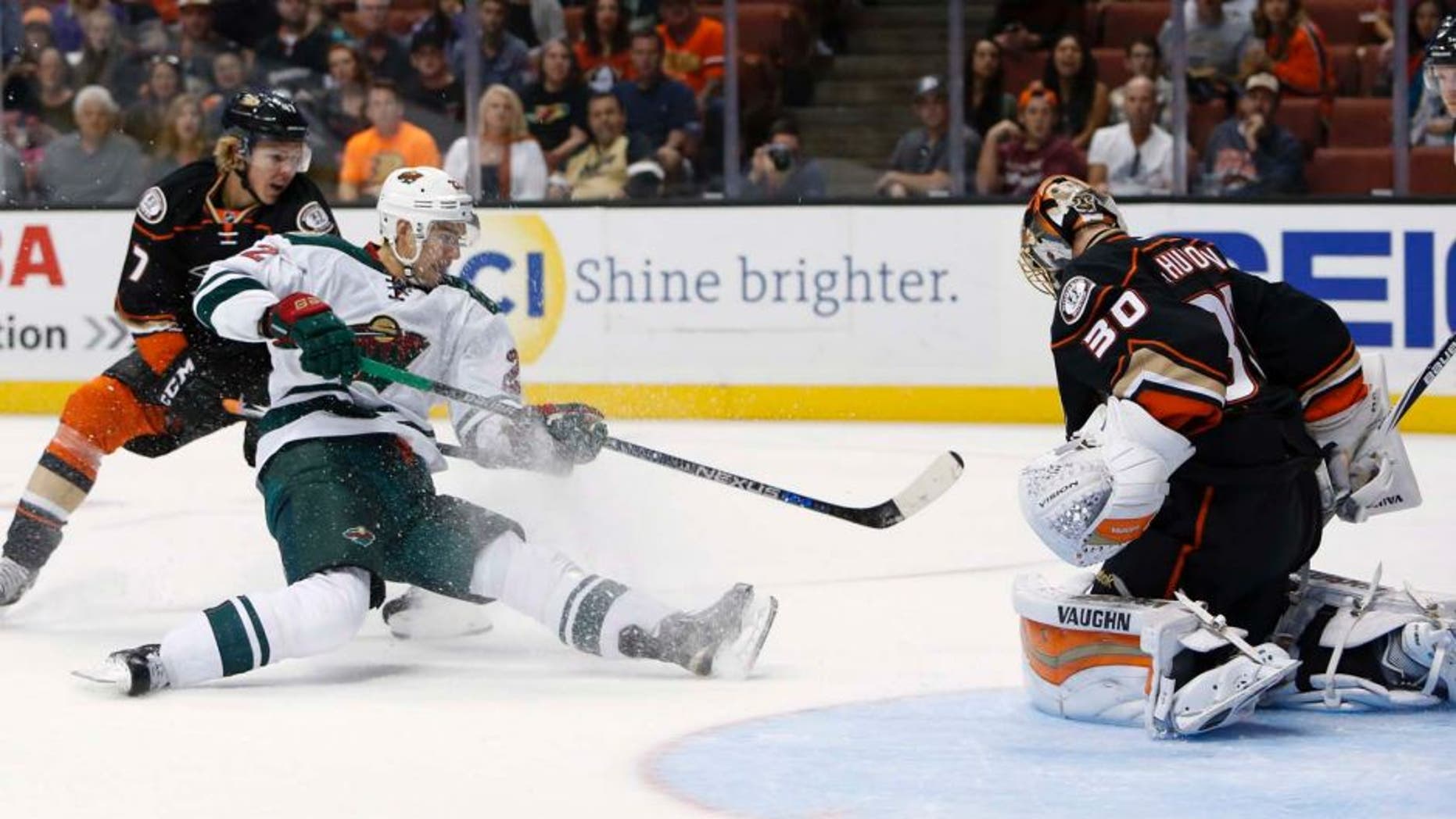 The Anaheim Ducks' Hampus Lindholm (left) can't stop the Minnesota Wild's Nino Niederreiter from scoring a goal past Anaheim Ducks goalie Anton Khudobin in the first period in Anaheim, Calif., on Sunday, Oct. 18, 2015.