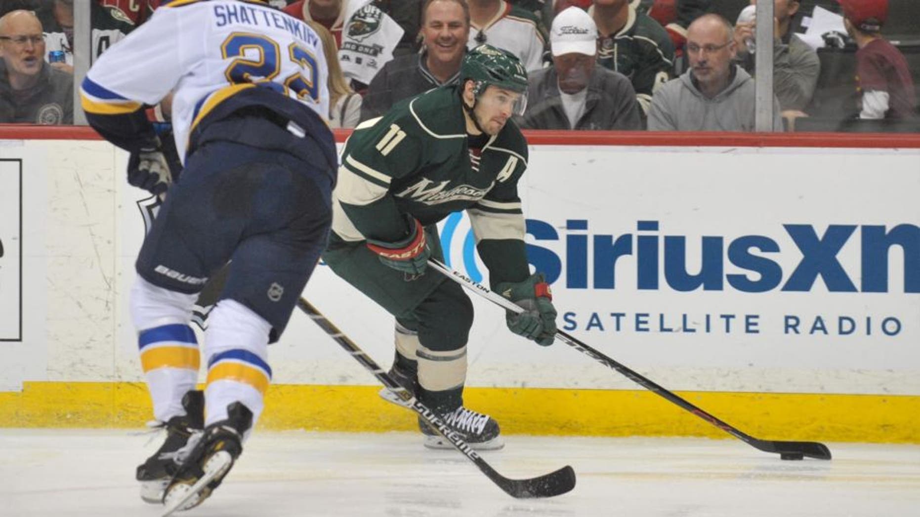 Apr 26, 2015; Saint Paul, MN, USA; Minnesota Wild forward Zach Parise (right) carries into the Blues zone defended by Saint Louis Blues defenseman Kevin Shattenkirk during the second period in Game 6 of the first round of the 2015 Stanley Cup Playoffs at Xcel Energy Center.